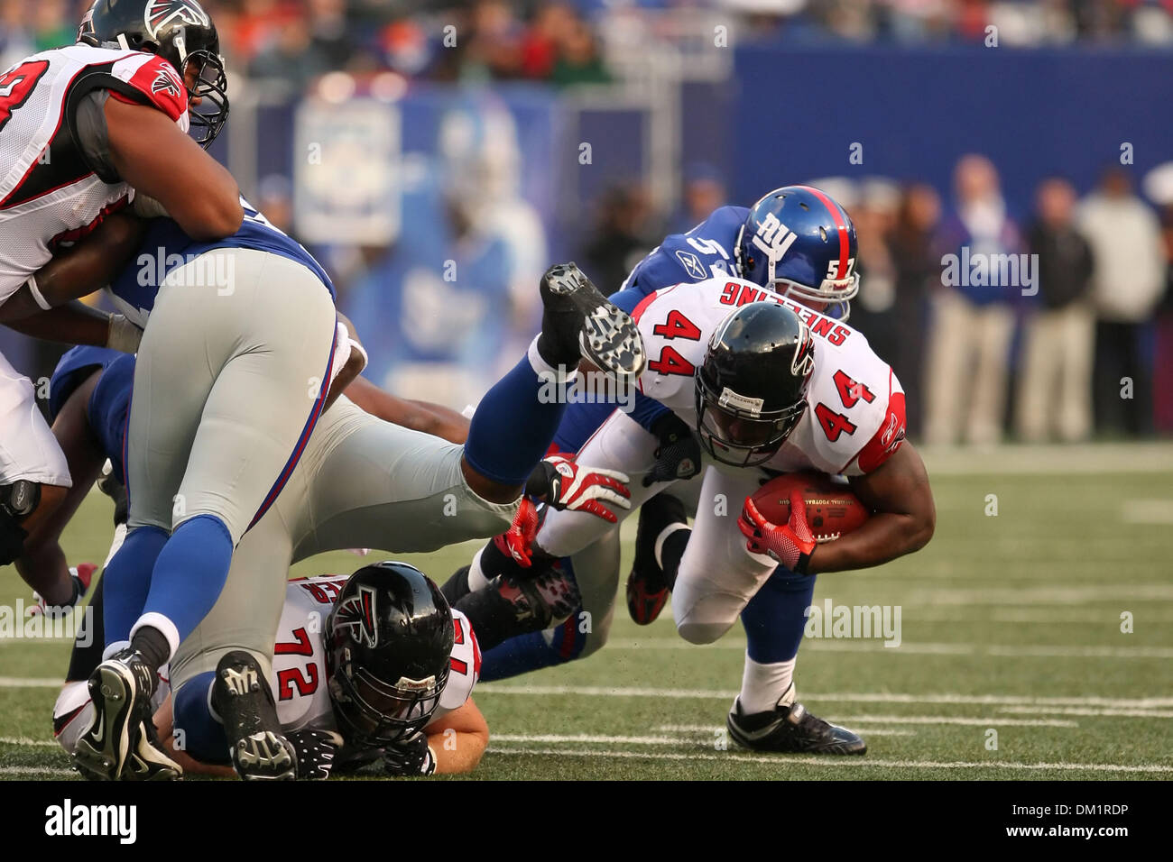 Falcons #44 Running Back Jason Snelling is taken down by Giants #57 ...