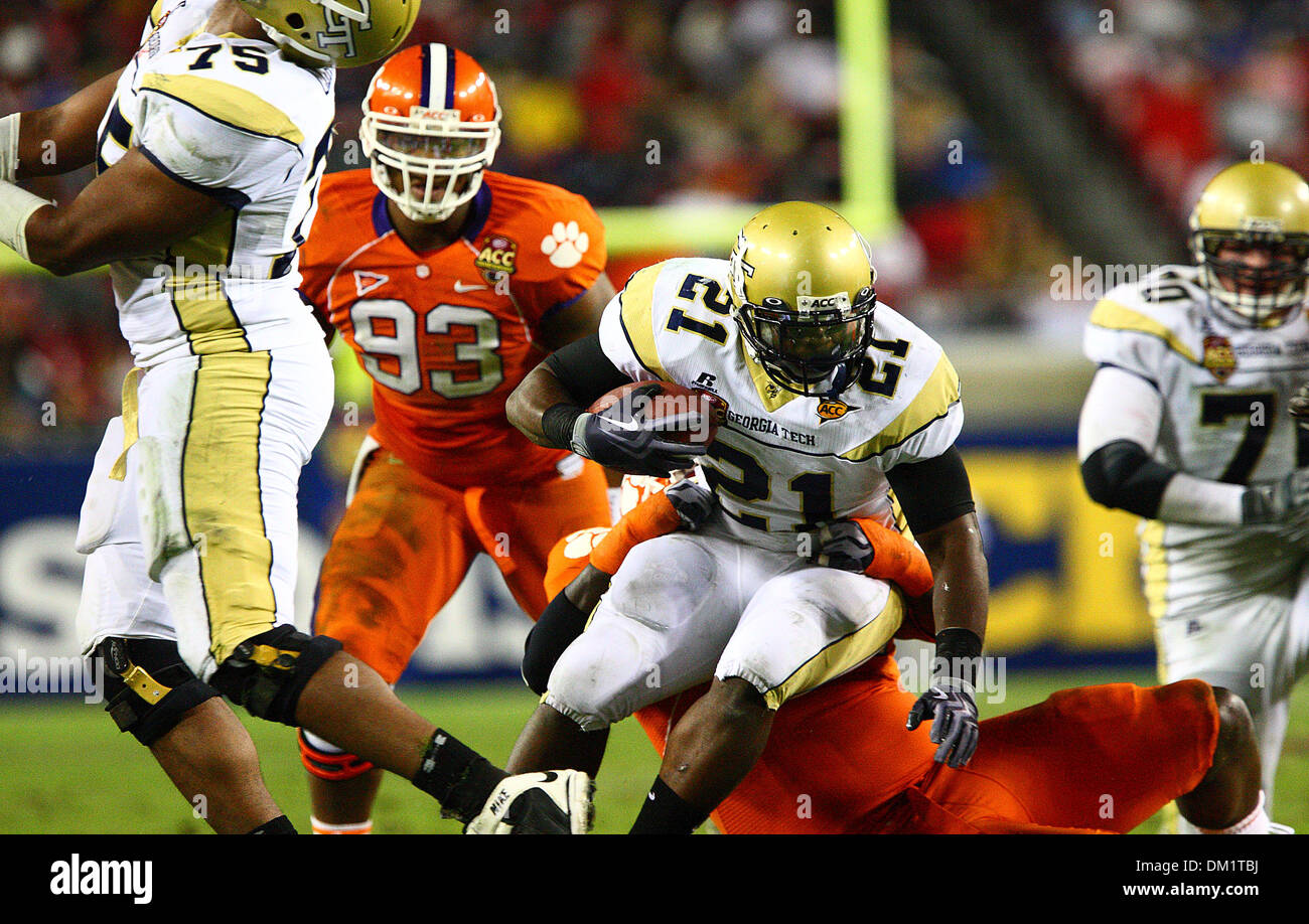 Georgia Tech running back Jonathan Dwyer #21 is taken down by a Clemson player during the first half of the Dr Pepper Atlantic Coast Conference Football Championship Game between the Georgia Tech Yellow Jackets and the Clemson Tigers being played at Raymond James Stadium in Tampa, FL. (Credit Image: © Chris Grosser/Southcreek Global/ZUMApress.com) Stock Photo