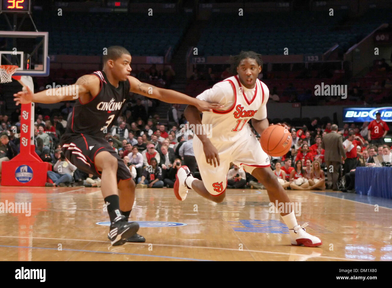 St Johns #11 Omari Lawrence drives past Cincinatti's #3 Dion Dixon.   St. Johns defeated Cincinatti 52-50 in the gamel held at Madison Square Garden, New York. (Credit Image: © Anthony Gruppuso/Southcreek Global/ZUMApress.com) Stock Photo