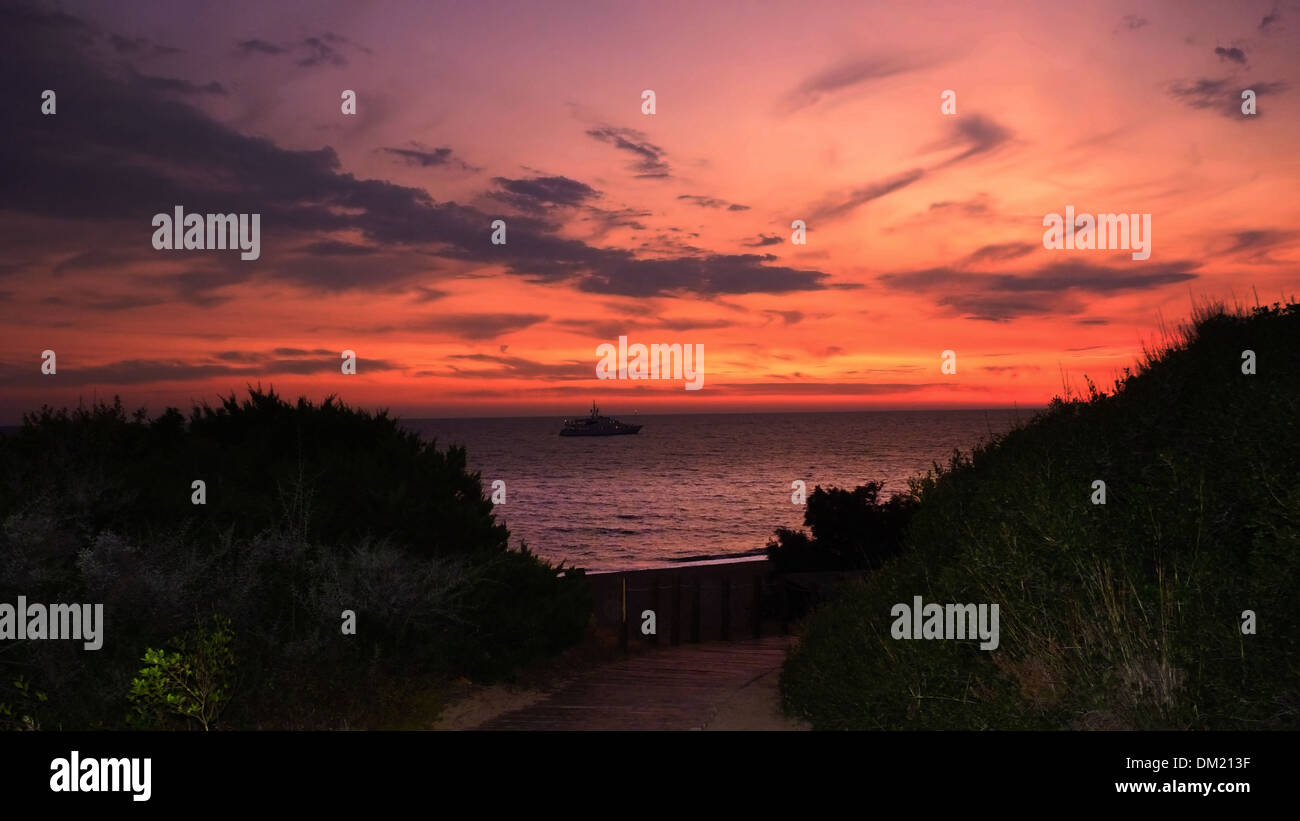 Sunset Sky at the Beach. A boat in the sea Stock Photo - Alamy
