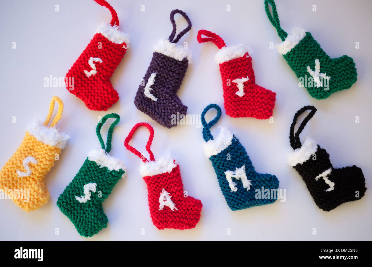 Knitted Christmas stockings with embroidered initials Stock Photo
