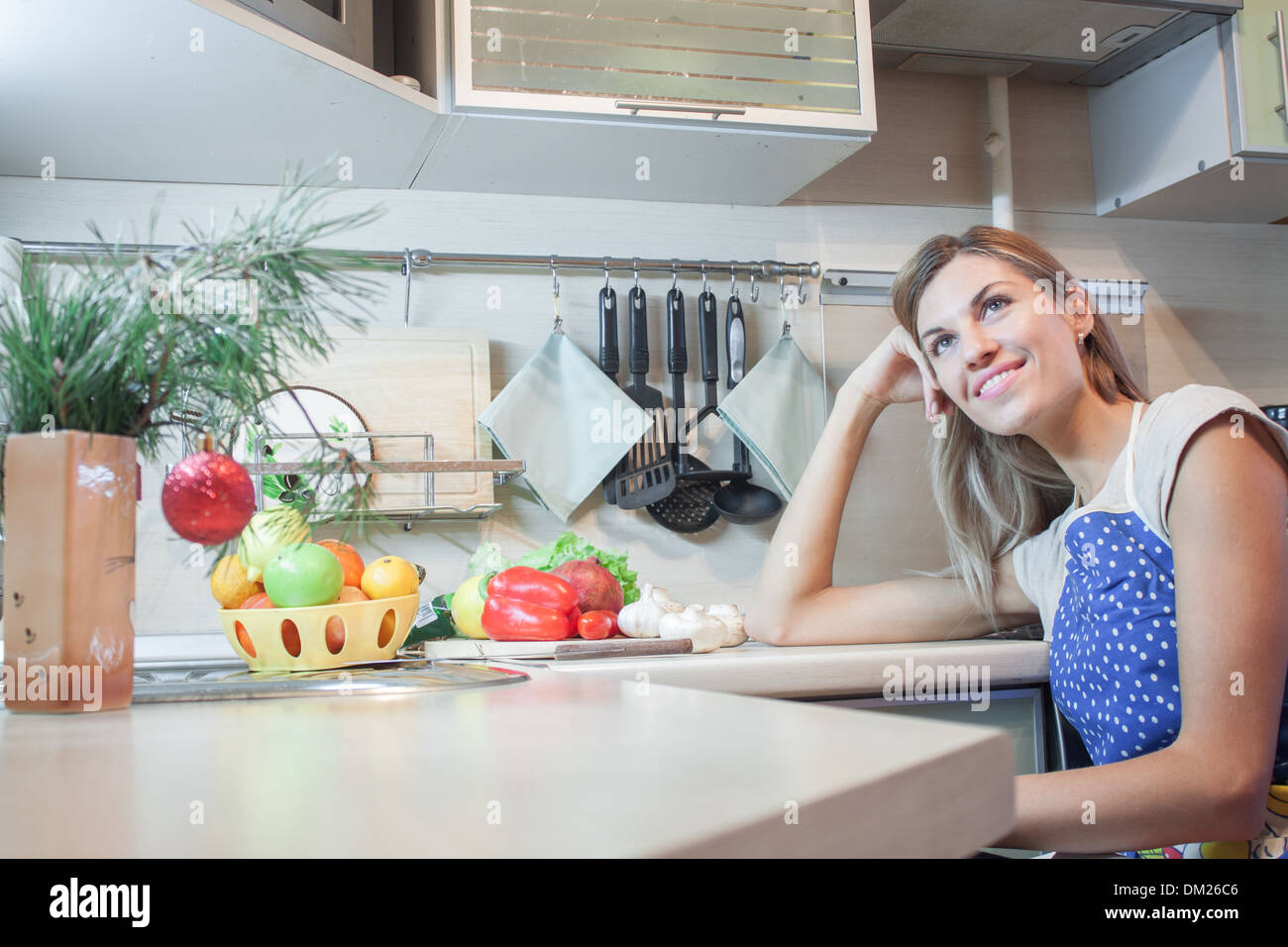 woman cooking kitchen happy 'healthy food' smiling thinking Stock Photo