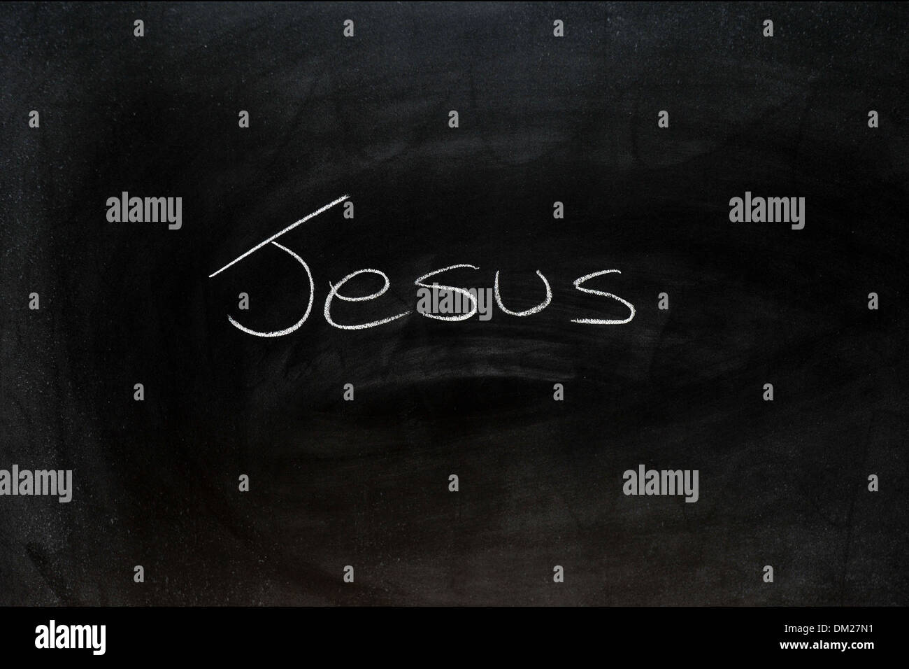 Close up of a blackboard with Jesus written on it in chalk. Stock Photo