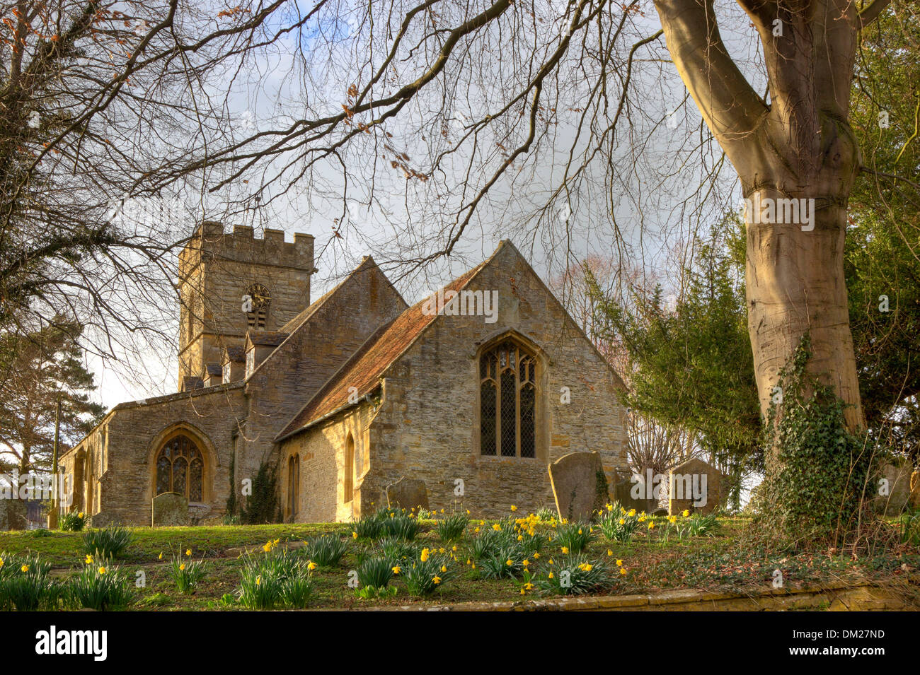 Pretty Worcestershire church with daffodils at springtime, Pebworth, England. Stock Photo