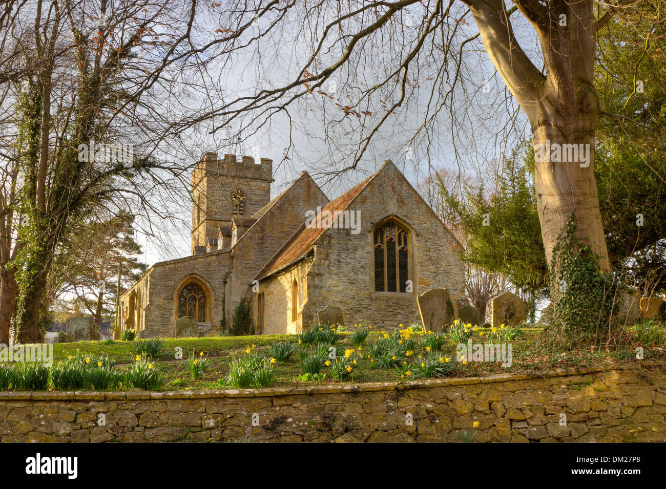 Pretty Worcestershire church with daffodils at springtime, Pebworth, England. Stock Photo