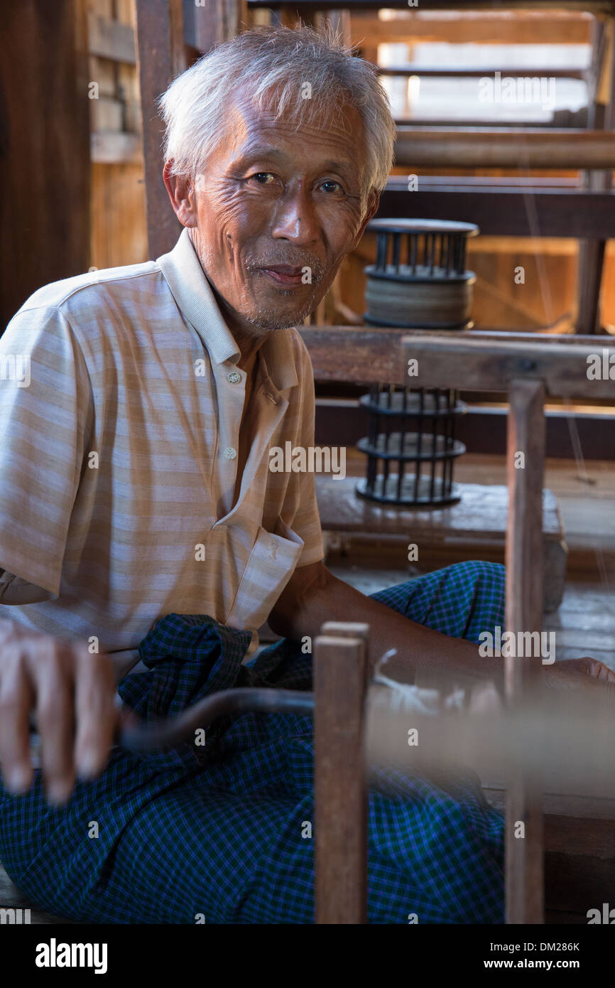 a man isolating silk on a bobbin, In Phaw Khone, Inle Lake, Myanmar (Burma) Stock Photo