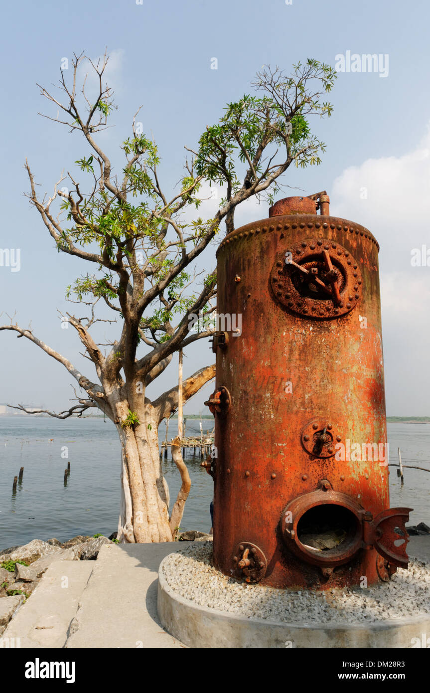 Old water boilers used as decoration on the seafront at Kochin in South India Stock Photo
