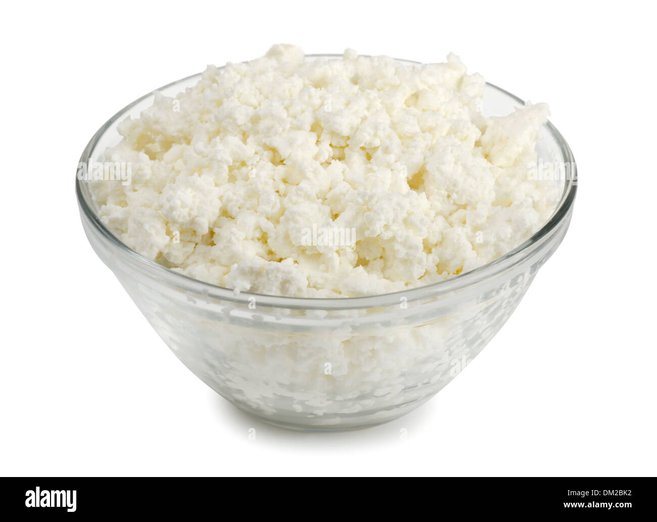 Glass bowl of fresh cottage cheese isolated on white Stock Photo