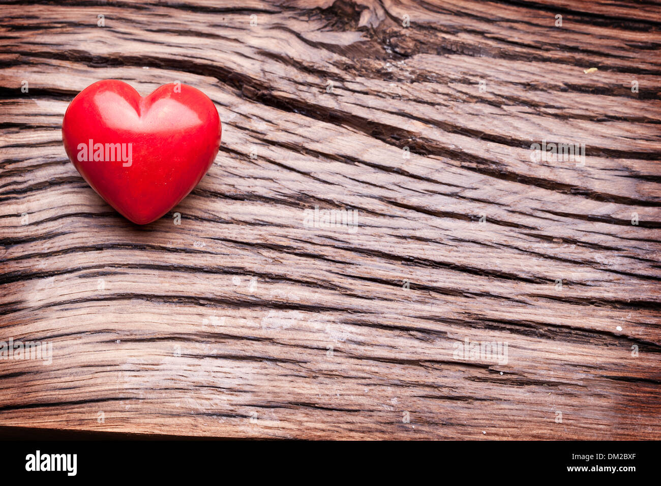 Valentines Day. Red heart on a dark wooden table. Stock Photo