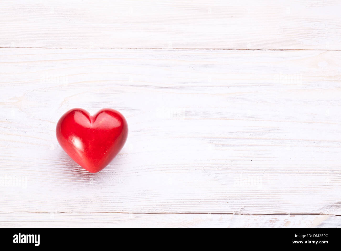 Valentines Day. Red heart on a white wooden table. Stock Photo