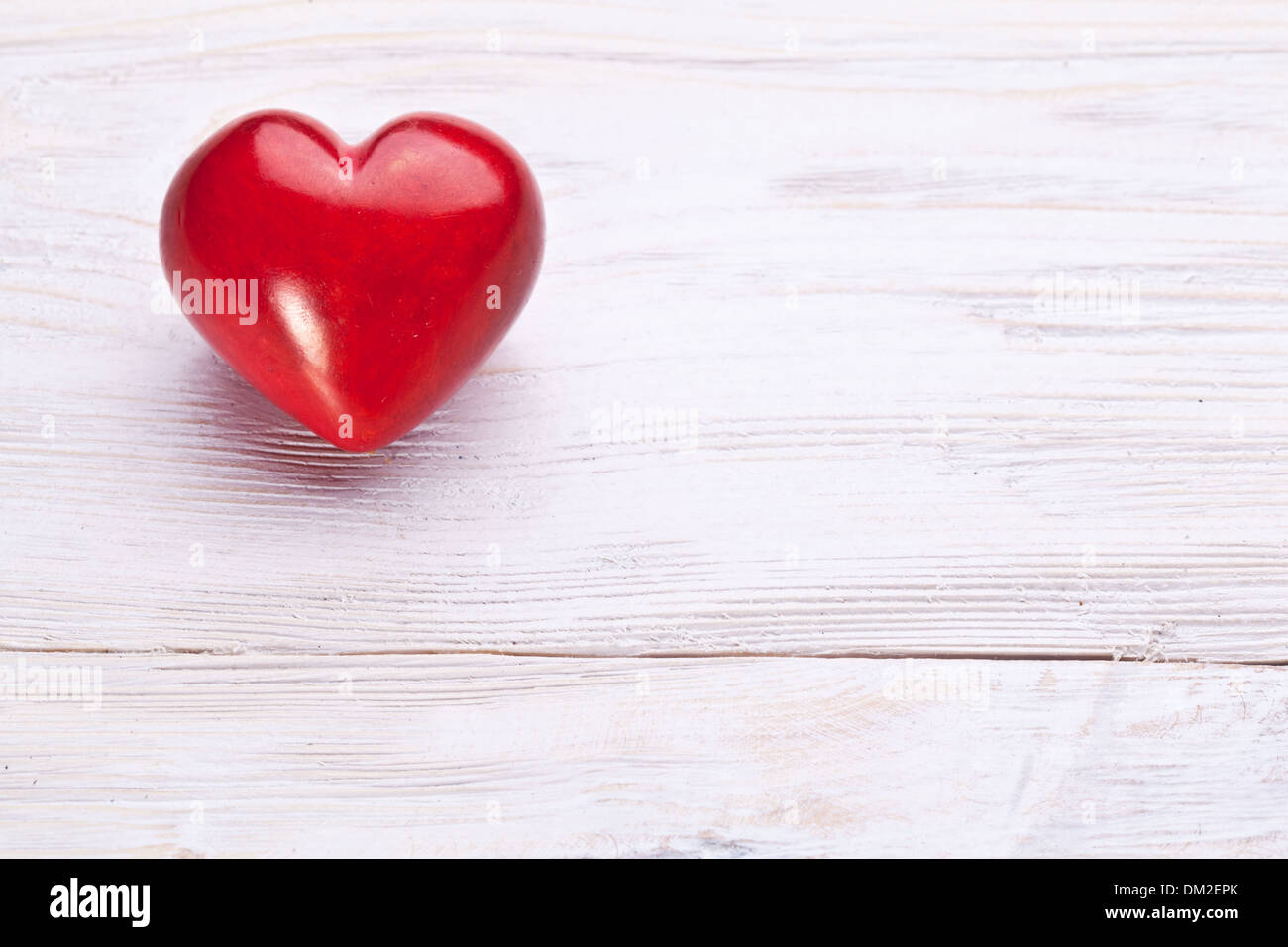 Valentines Day. Red heart on a white wooden table. Stock Photo