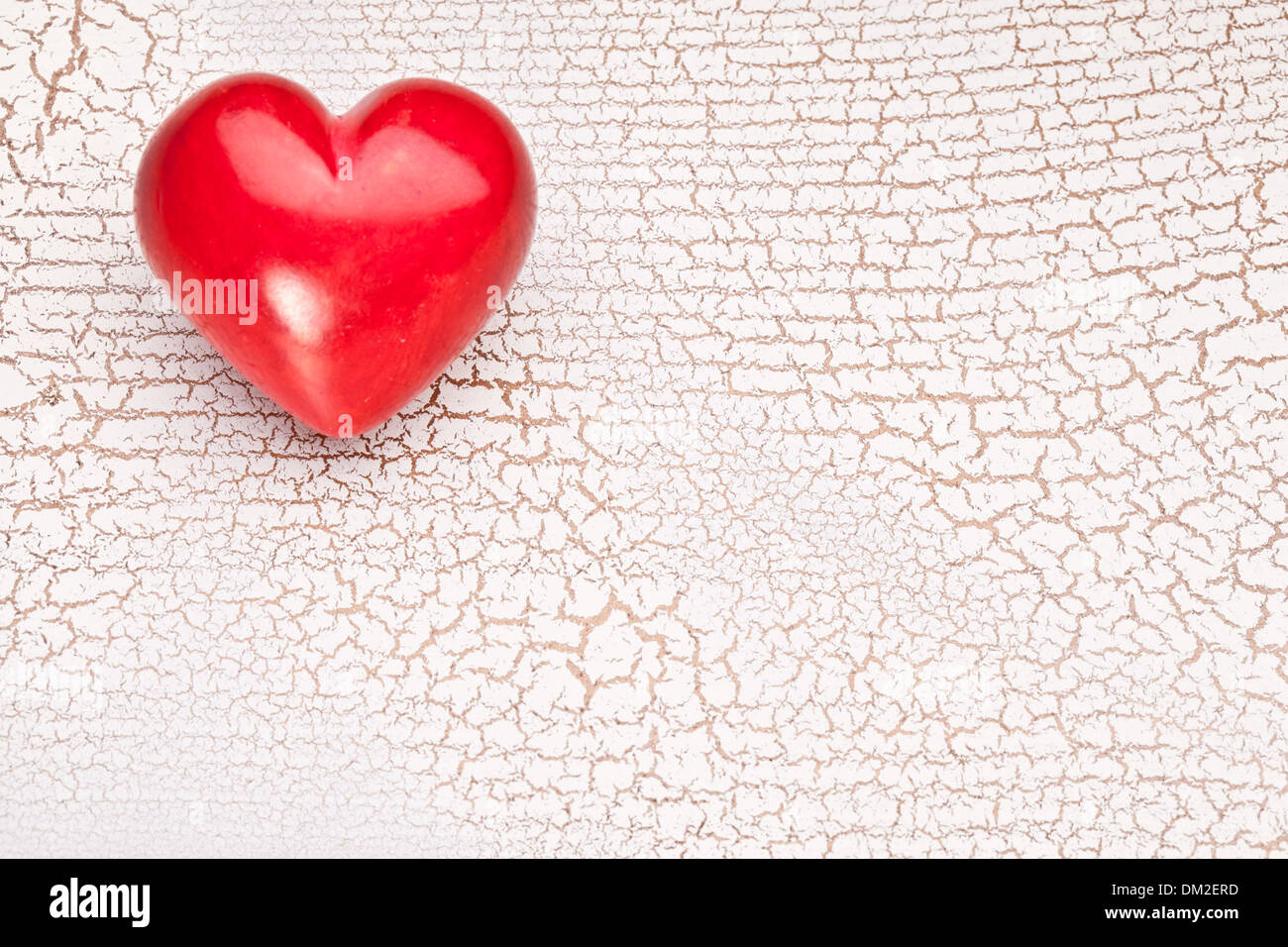Valentines Day. Red heart on a white craquelure wooden table. Stock Photo