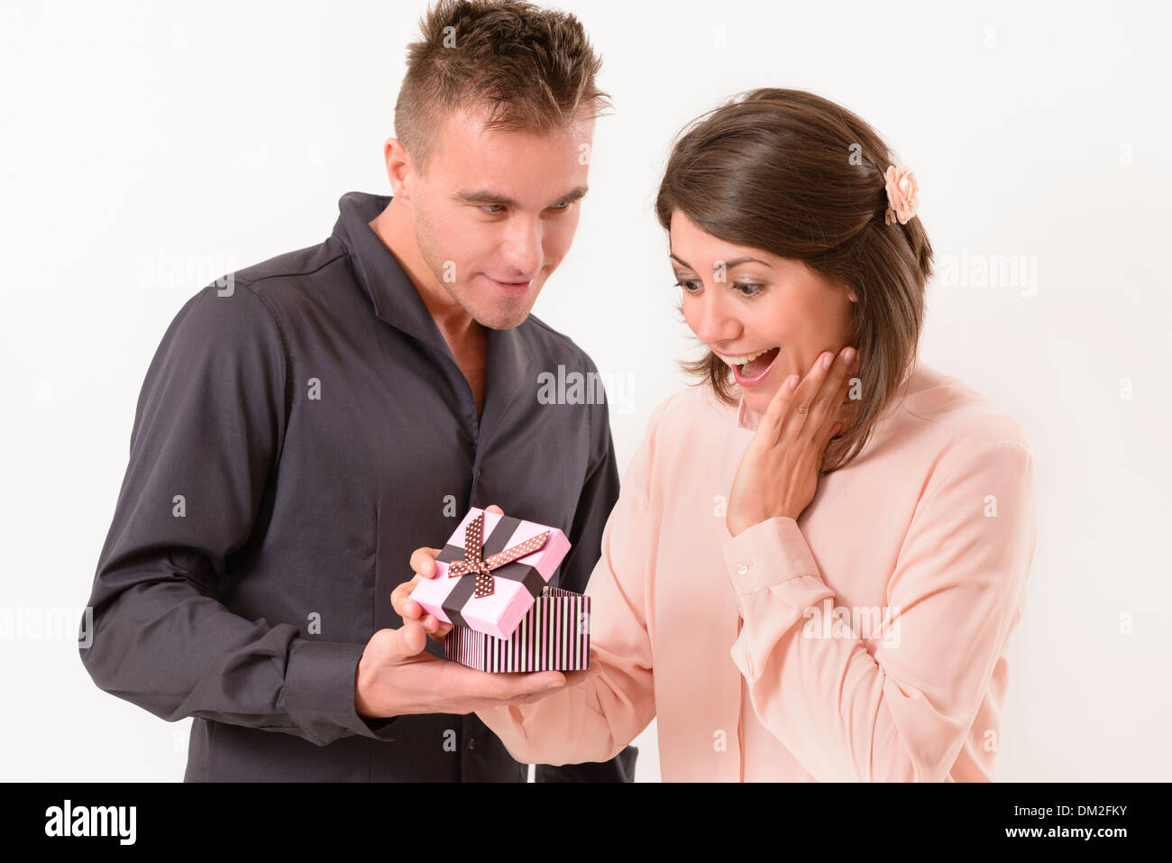 Young man giving a present to his girlfriend Stock Photo