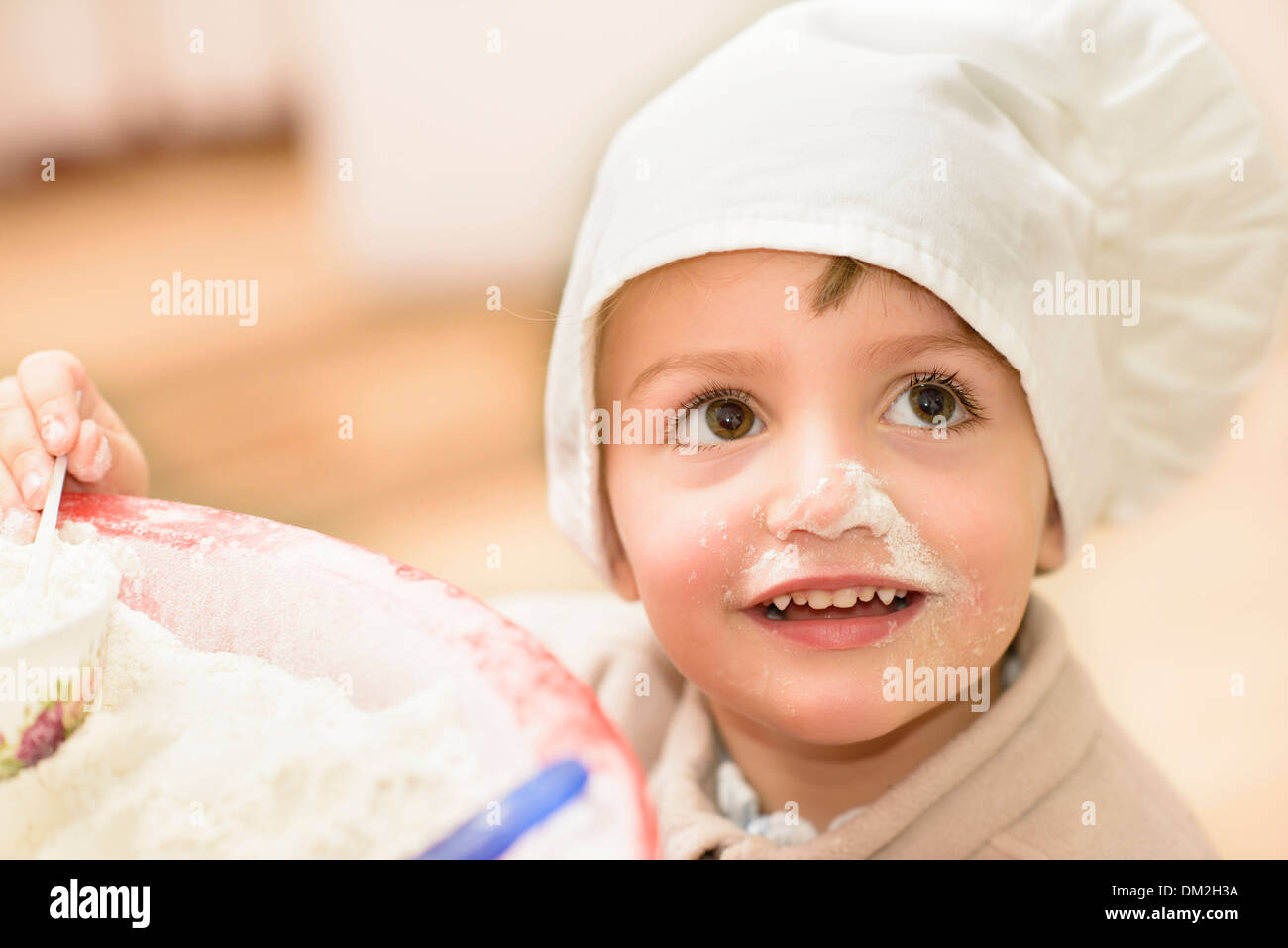 A sweet child playing in the kitchen Stock Photo
