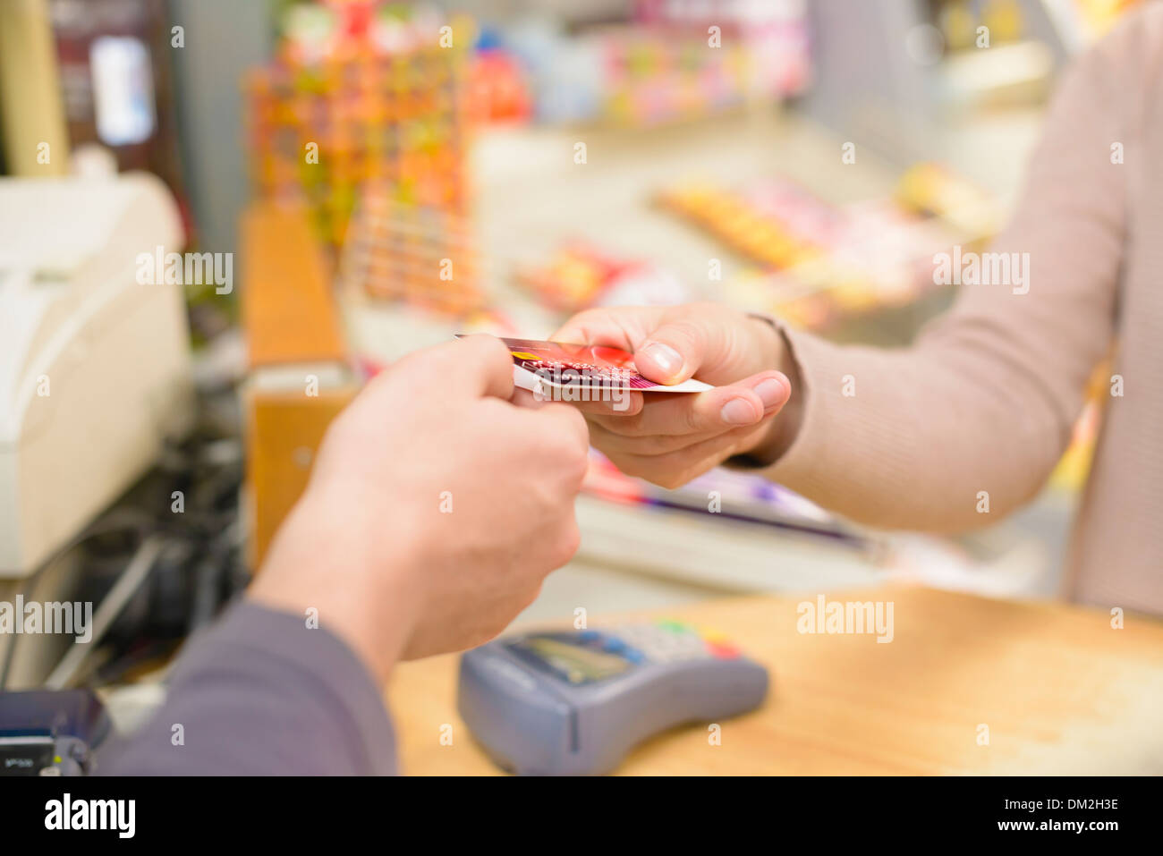 Young woman paying in a shop Stock Photo