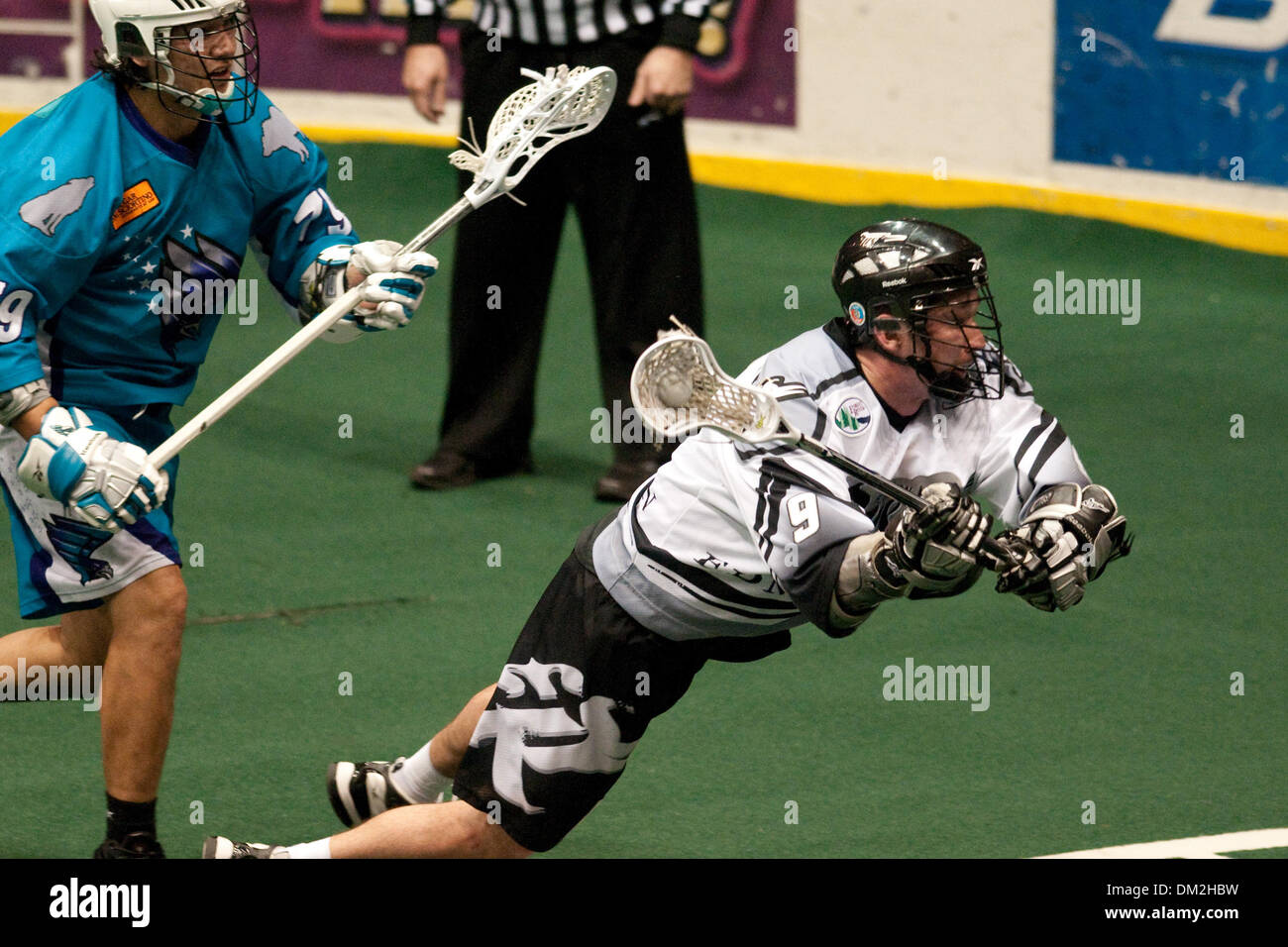 Edmonton Rush forward Gavin Prout (9) dives to take a shot on goal while Rochester Knighthawks defender Sid Smith (79) looks on. Edmonton defeated Rochester 12-11 at the Blue Cross Arena in Rochester, NY. (Credit Image: © Mark Konezny/Southcreek Global/ZUMApress.com) Stock Photo