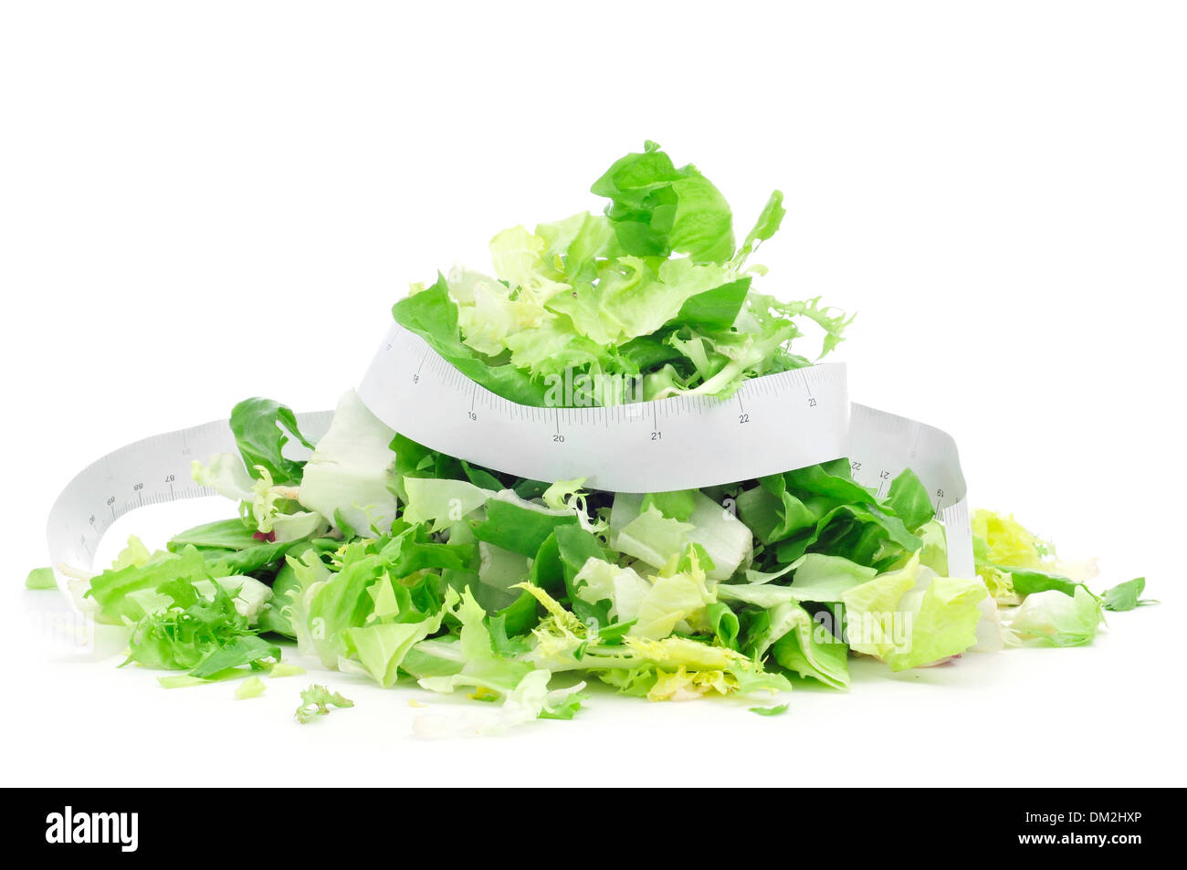 closeup of a pile of salad leaves and a measuring tape, symbolizing the dieting concept or to stay fit Stock Photo