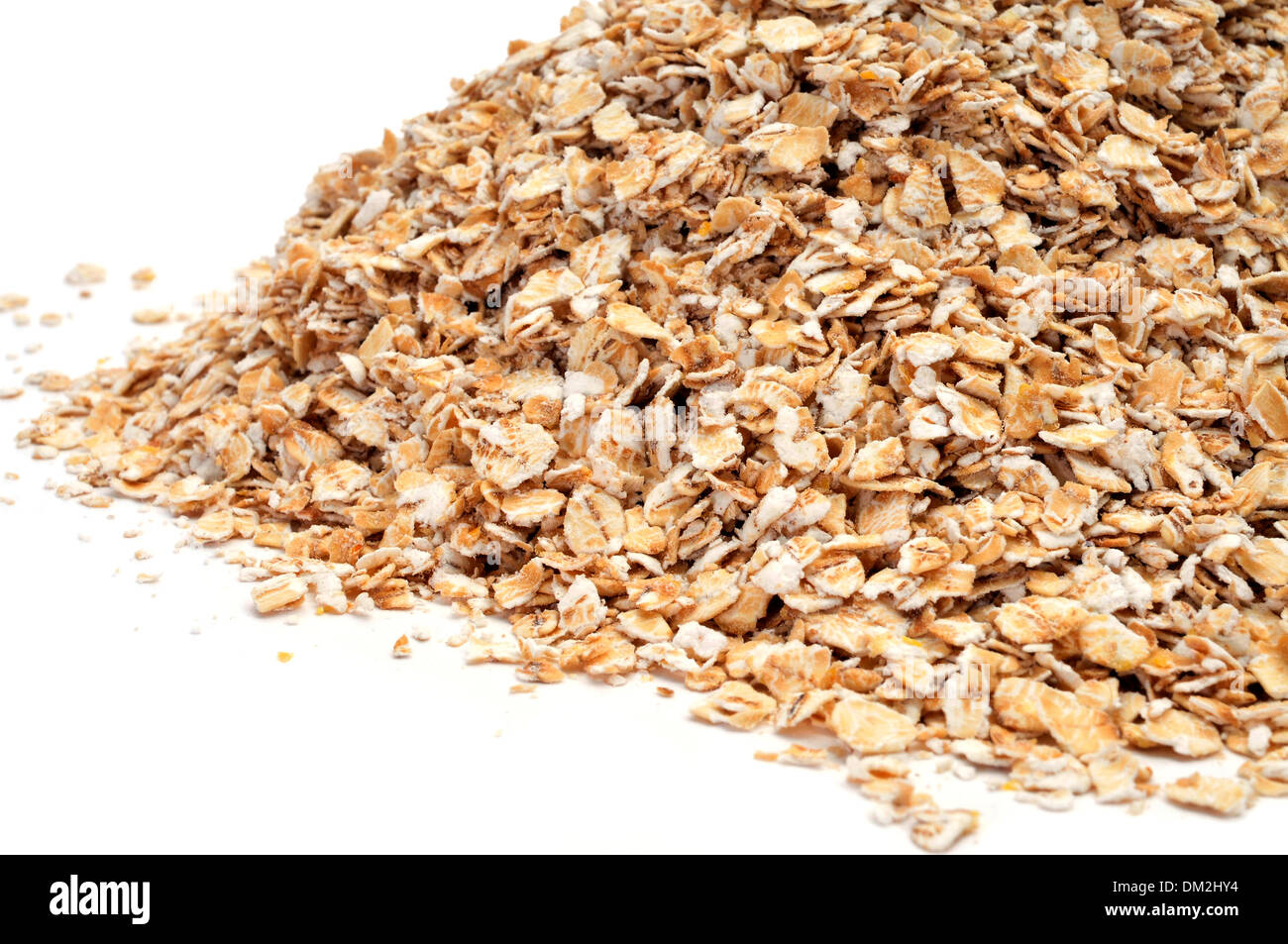 a pile of rolled oats on a white background Stock Photo - Alamy