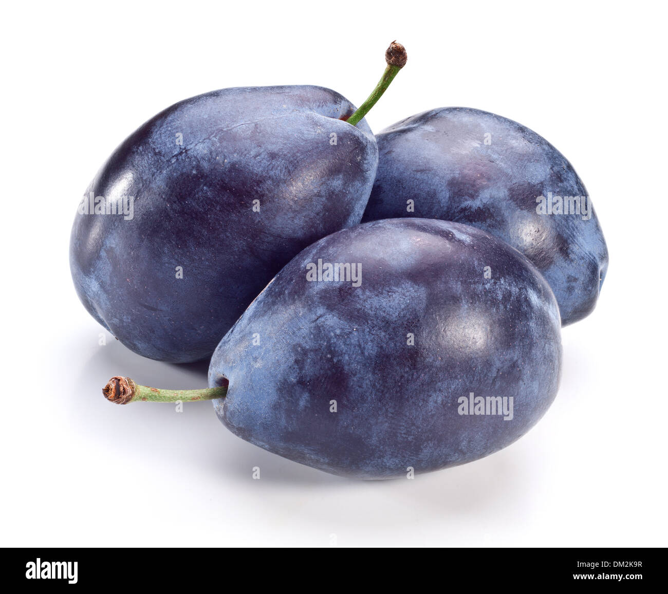 Three plums with leaf isolated on a white background. Stock Photo