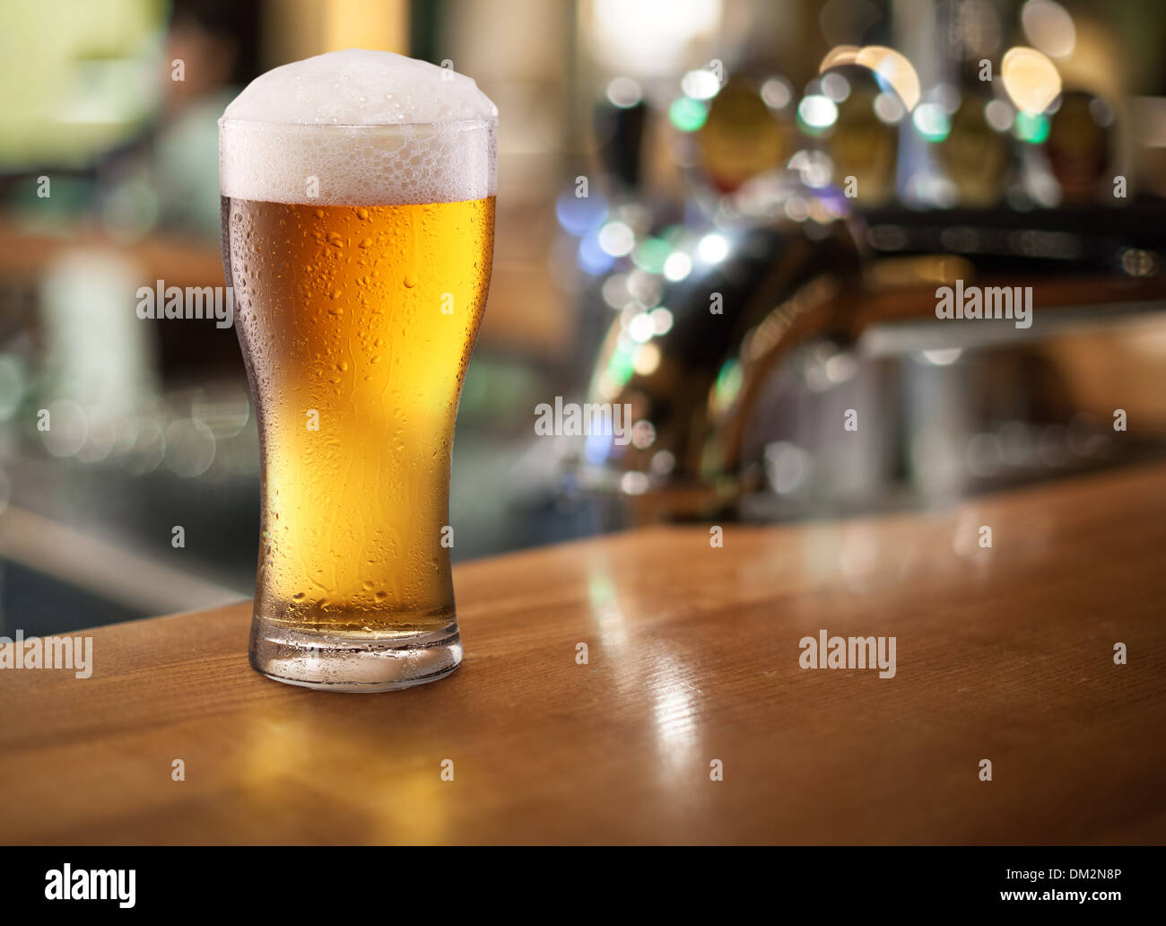 Photo of cold beer glass on a bar. Closeup. Stock Photo