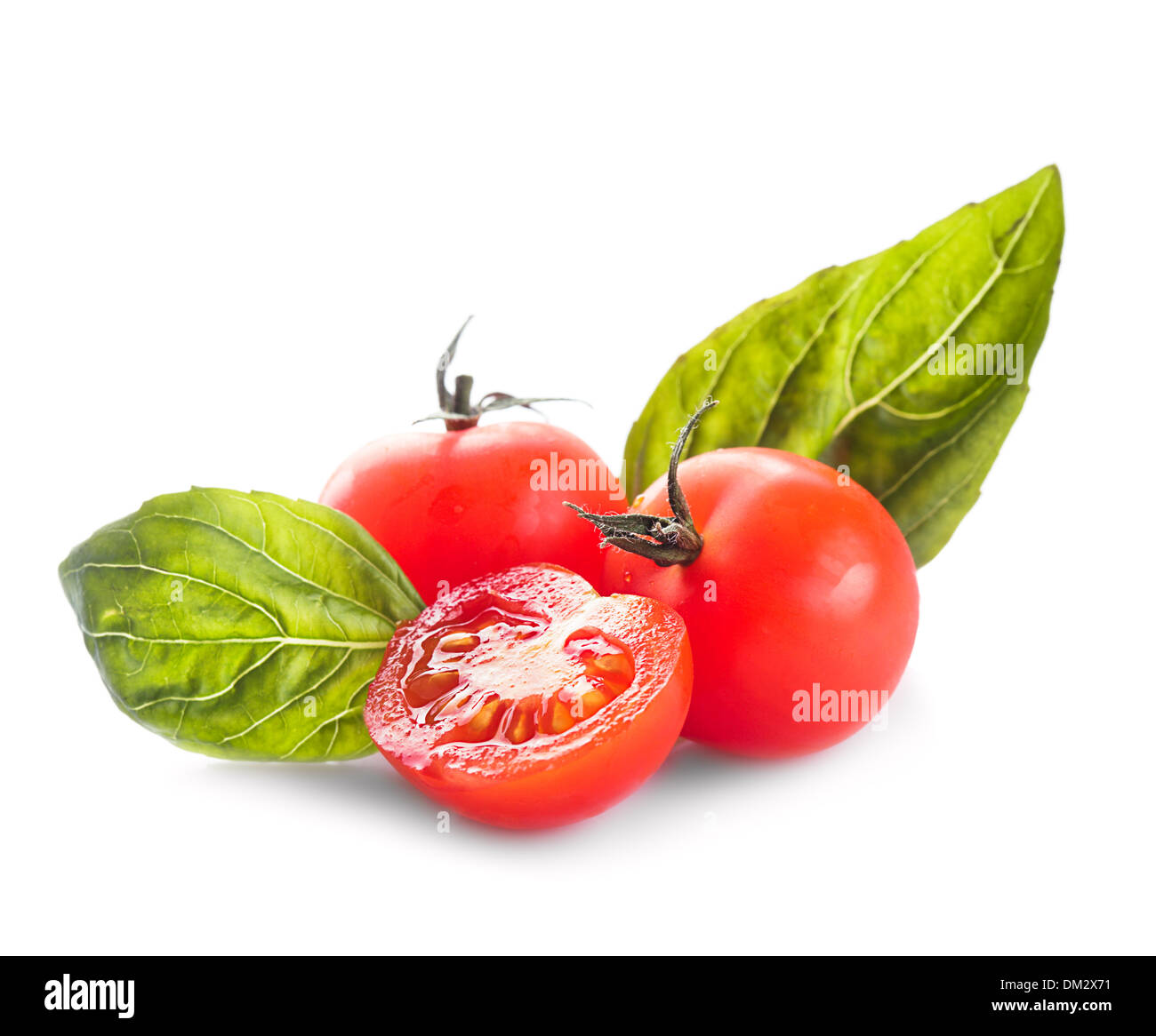 Cherry tomatoes and basil leaves isolated on white Stock Photo - Alamy