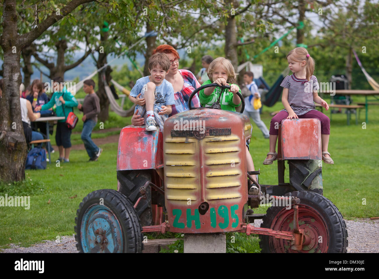 Switzerland Europe family child children agriculture play game plays games spare time adventure family children young Stock Photo