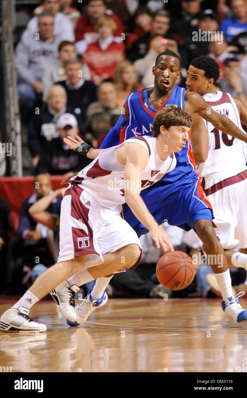 Temple guard Juan Fernandez #4 dribbles past a Kansas defender Kansas won the game 84-52 in a game being played at The Liacouras Center in Philadelphia, Pennsylvania. (Credit Image: © Mike McAtee/Southcreek Global/ZUMApress.com) Stock Photo