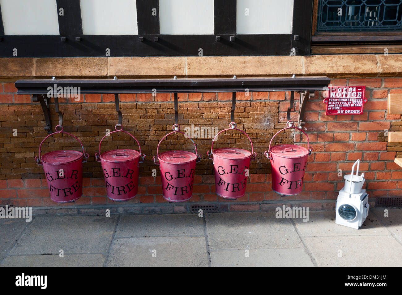 A line of 5 GER fire buckets with lids at Wolferton, the now closed 'Royal Station' for Sandringham in Norfolk. Stock Photo