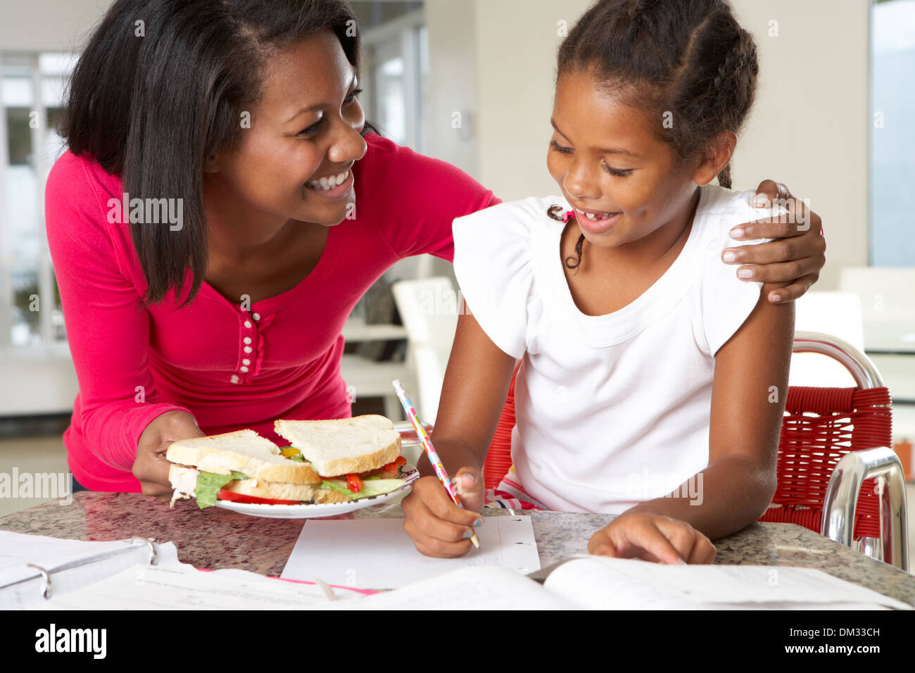 Mother Brings Daughter Sandwich Whilst She Studies Stock Photo