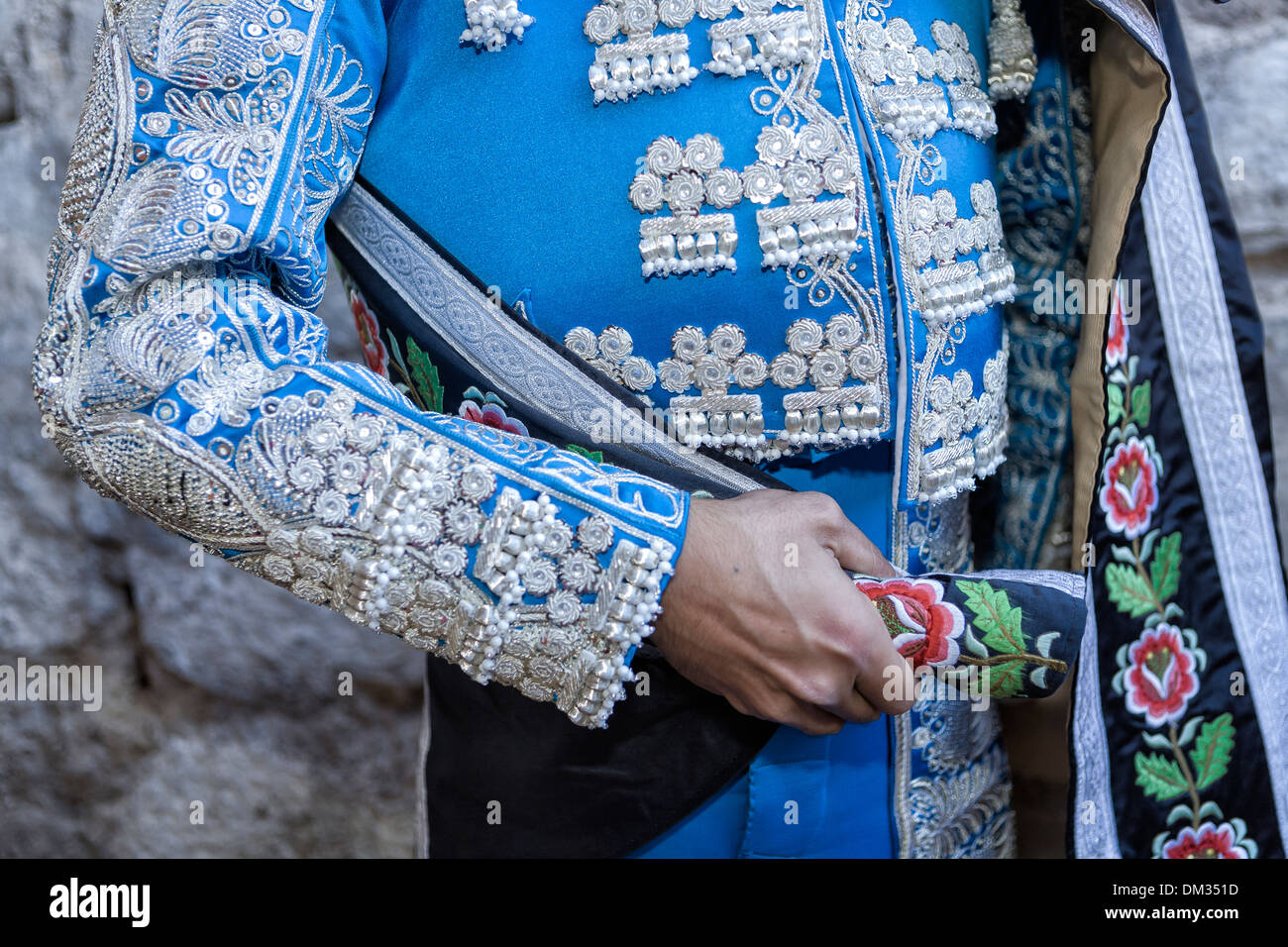 Spanish Bullfighter with blue dress and silver ornaments, the mantle is placed to start the paseíllo before beginning the bullfi Stock Photo