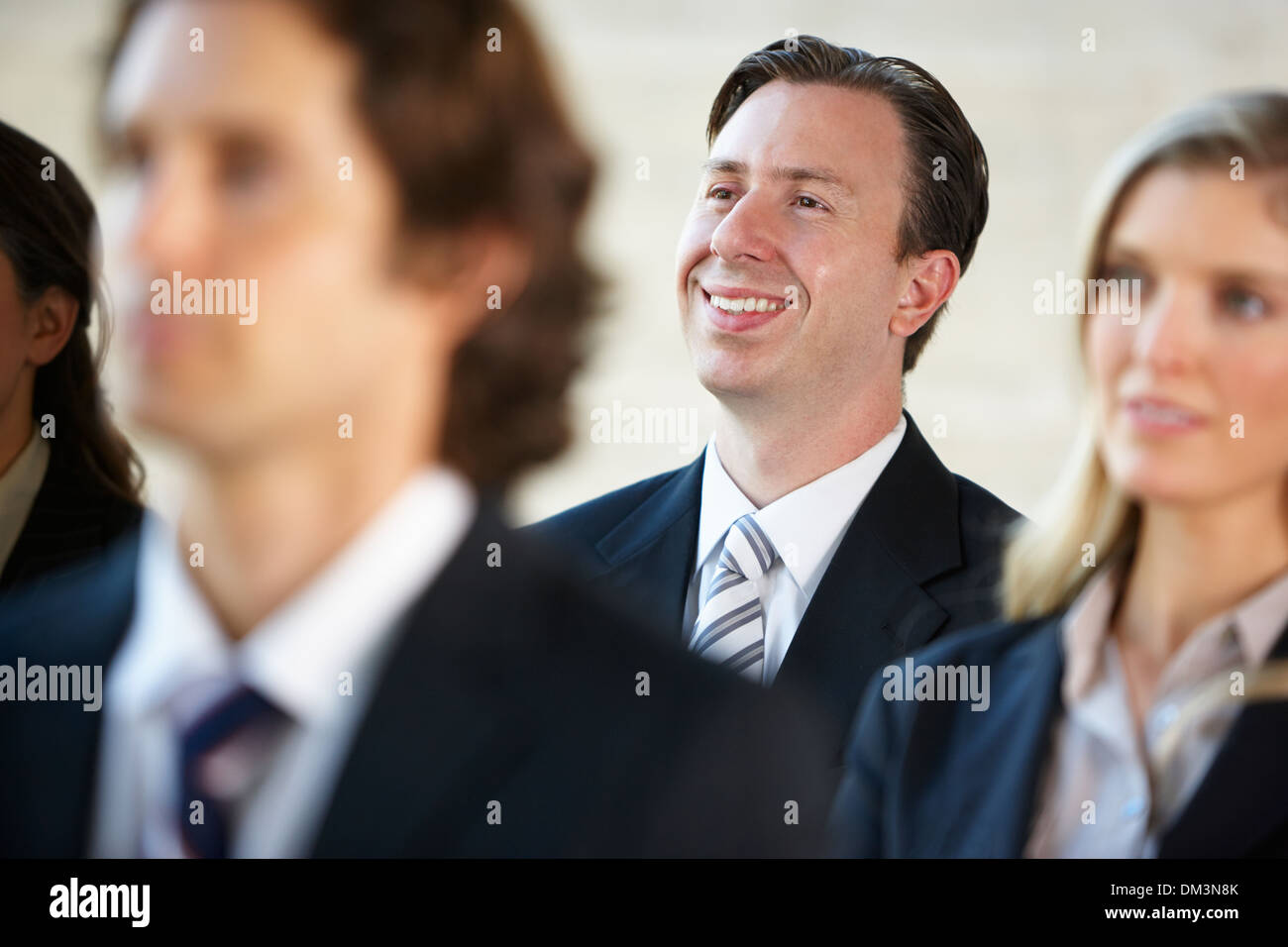 Businessman Listening To Speaker At Conference Stock Photo