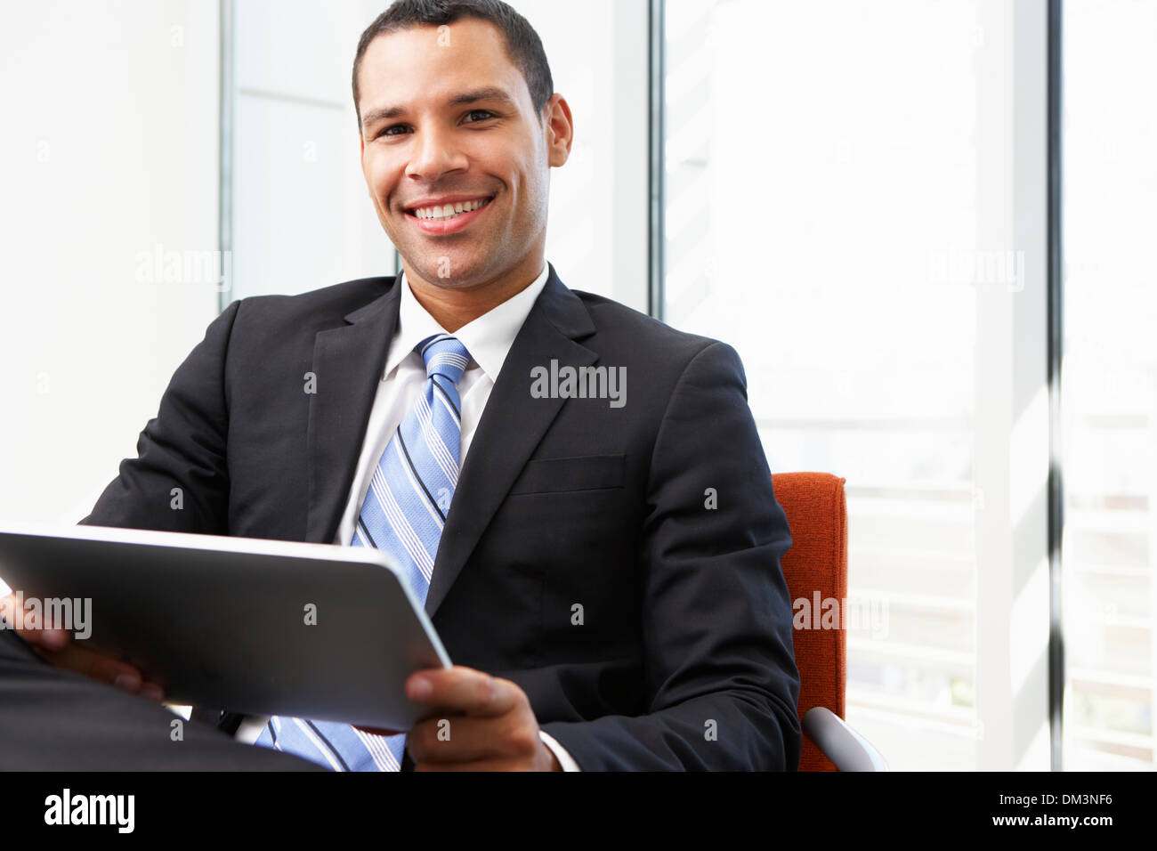 Businessman Using Digital Tablet In Office Stock Photo