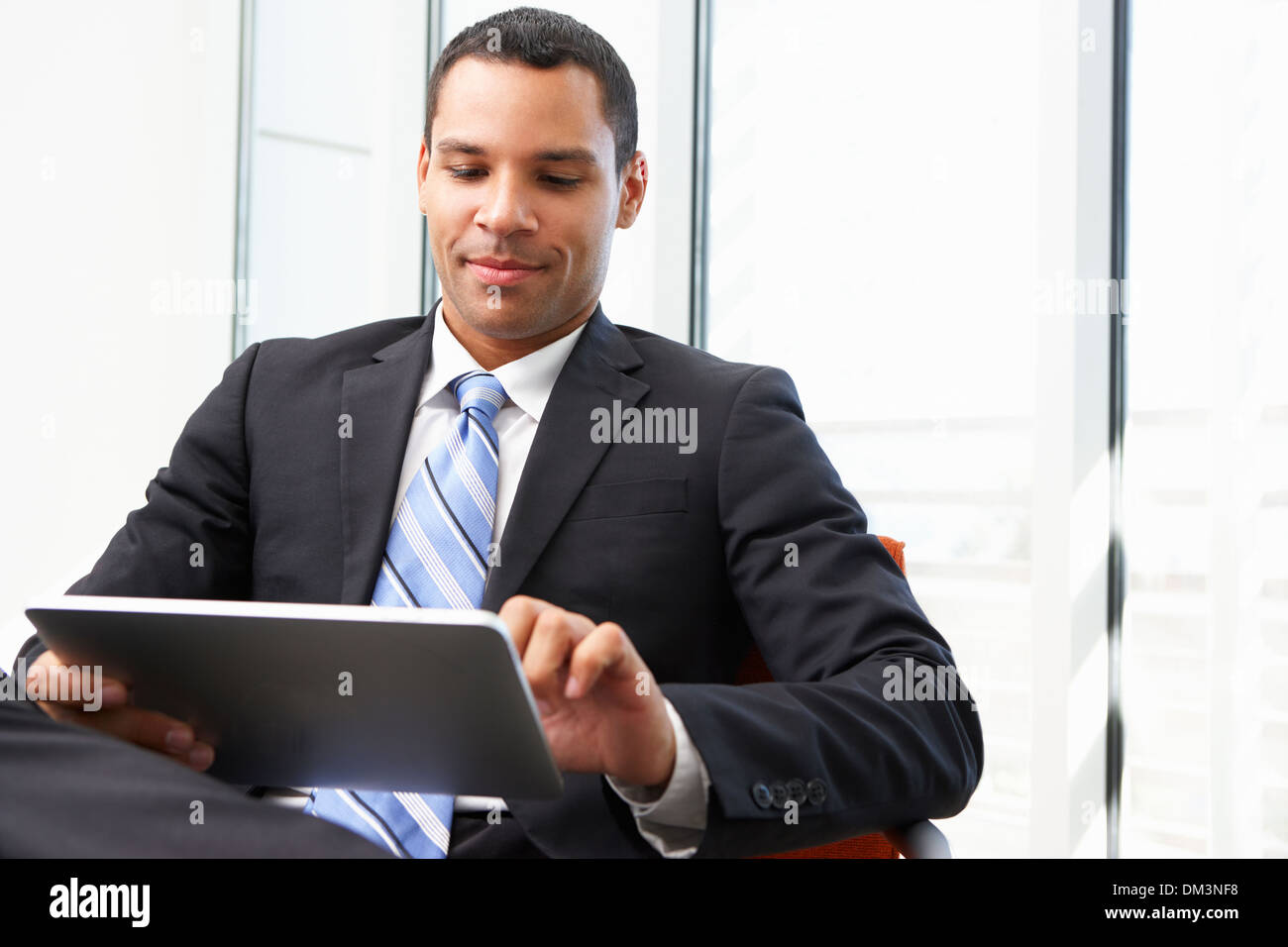 Businessman Using Digital Tablet In Office Stock Photo
