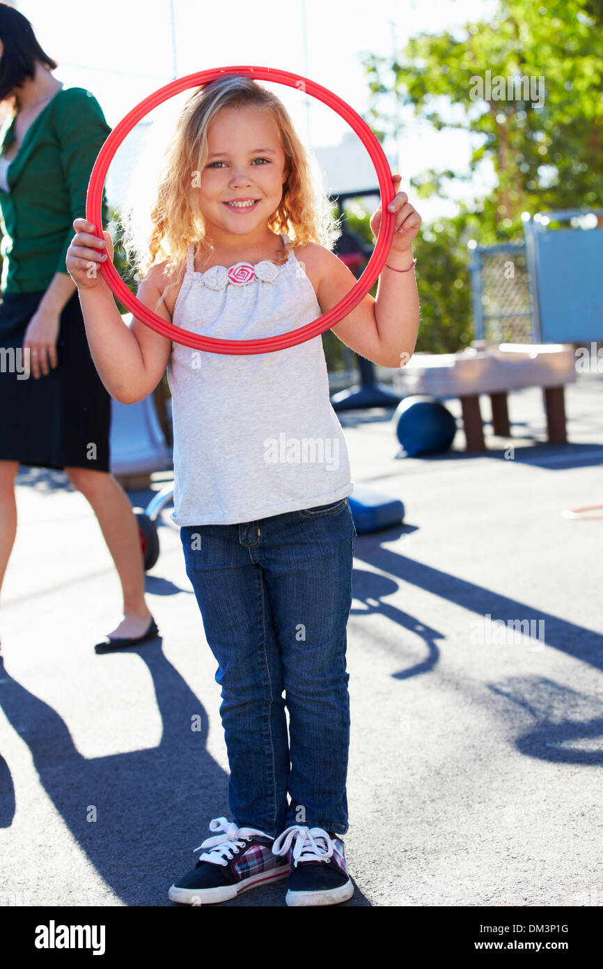 Girl In School Playground With Hoop Stock Photo