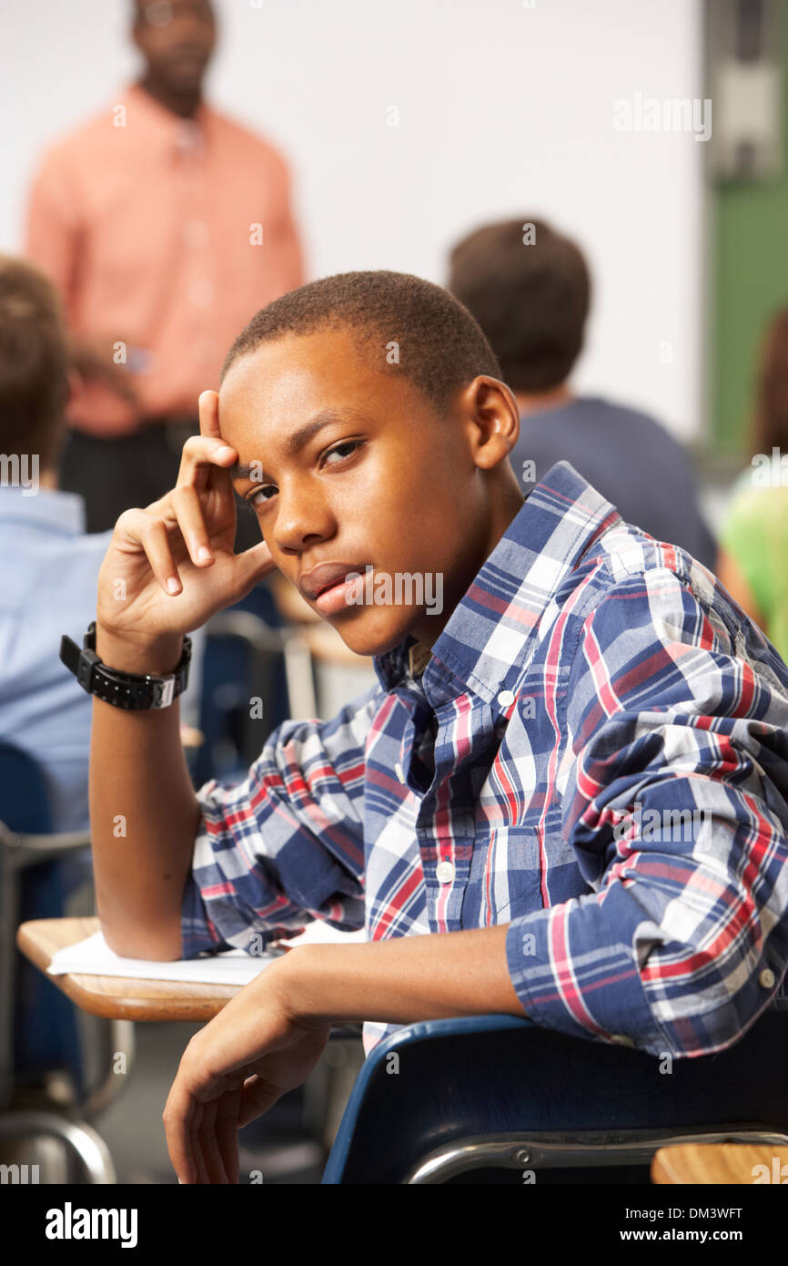 Bored Male Teenage Pupil In Classroom Stock Photo - Alamy