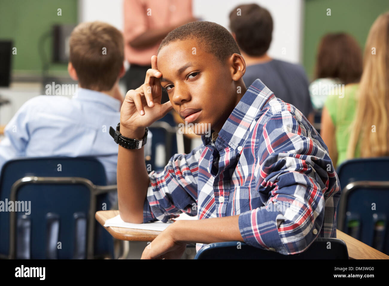 Bored Male Teenage Pupil In Classroom Stock Photo - Alamy