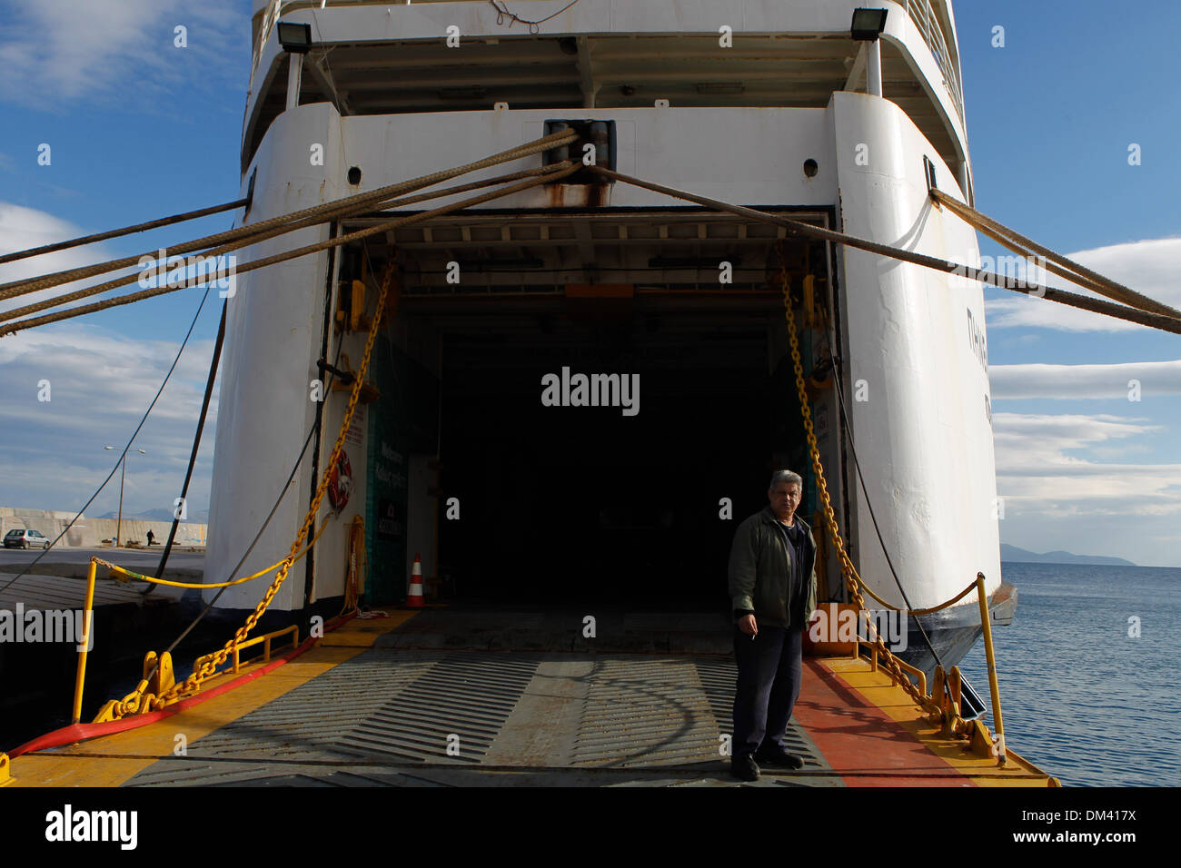 Ship crew guiding heavy duty mooring rope during docking procedure