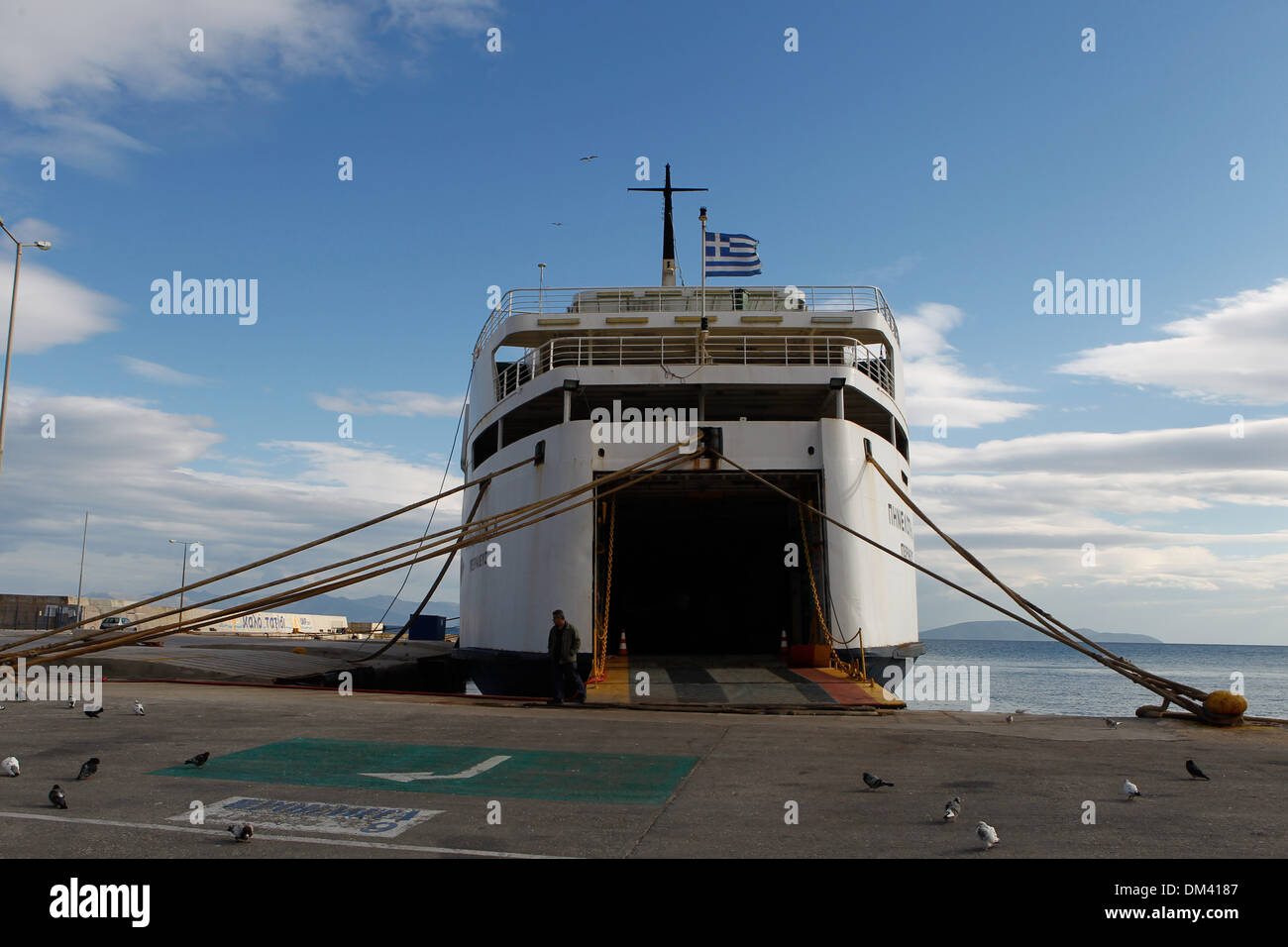Ship crew guiding heavy duty mooring rope during docking procedure ...