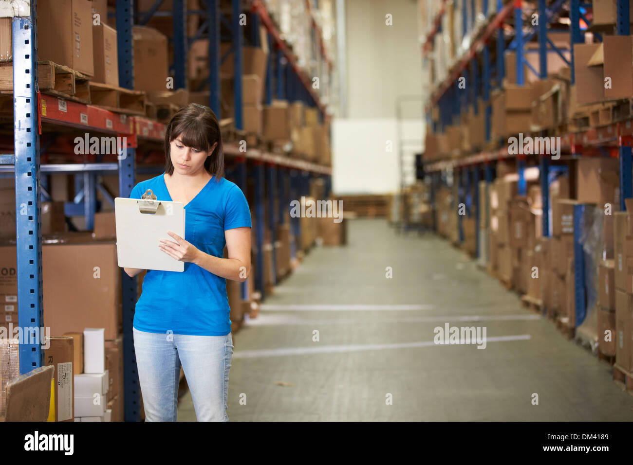 Female Worker In Distribution Warehouse Stock Photo