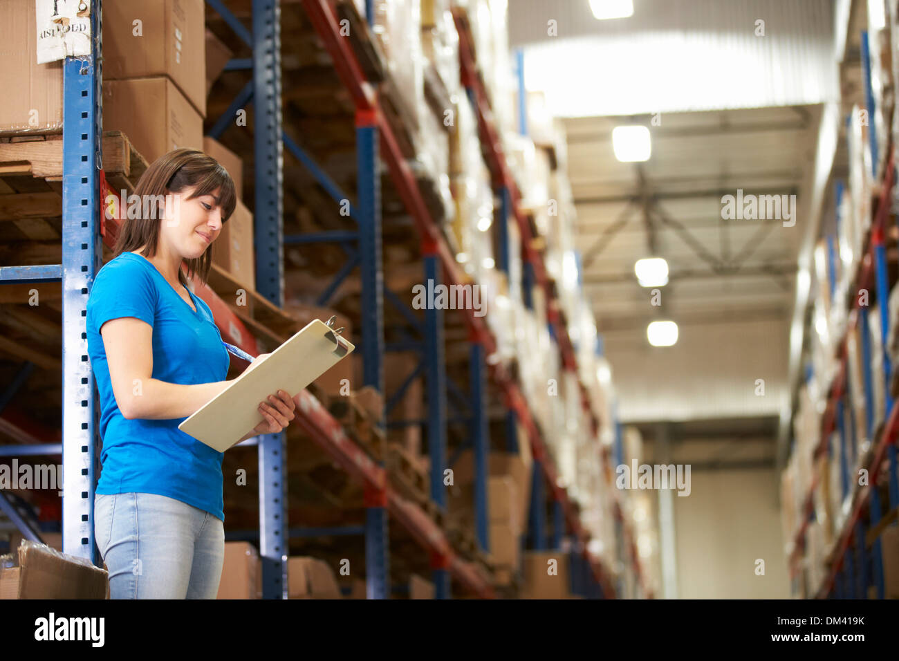 Female Worker In Distribution Warehouse Stock Photo