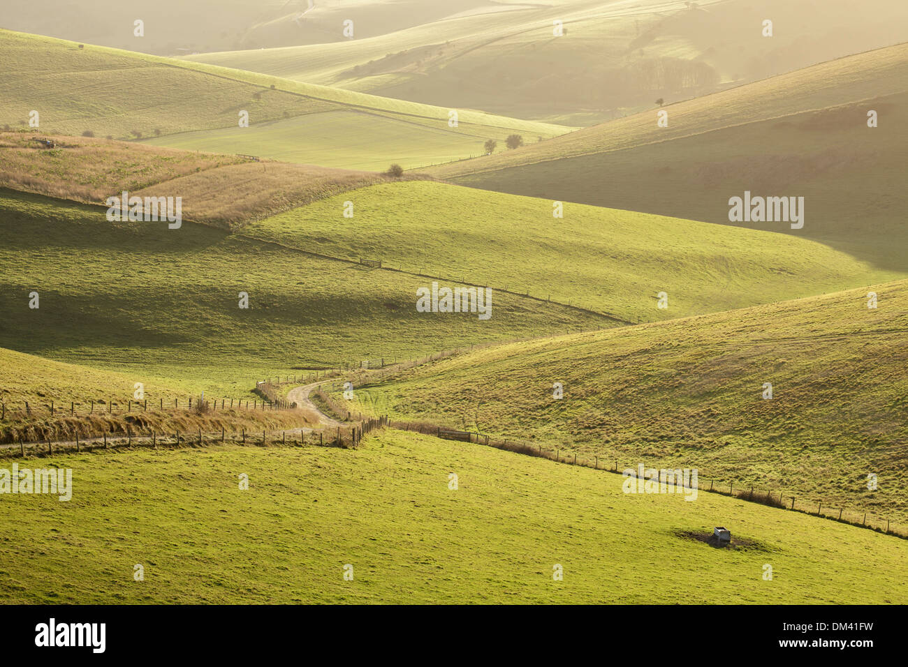 Sunset light illuminating the interlocking hills of the South Downs near Lewes in East Sussex Stock Photo