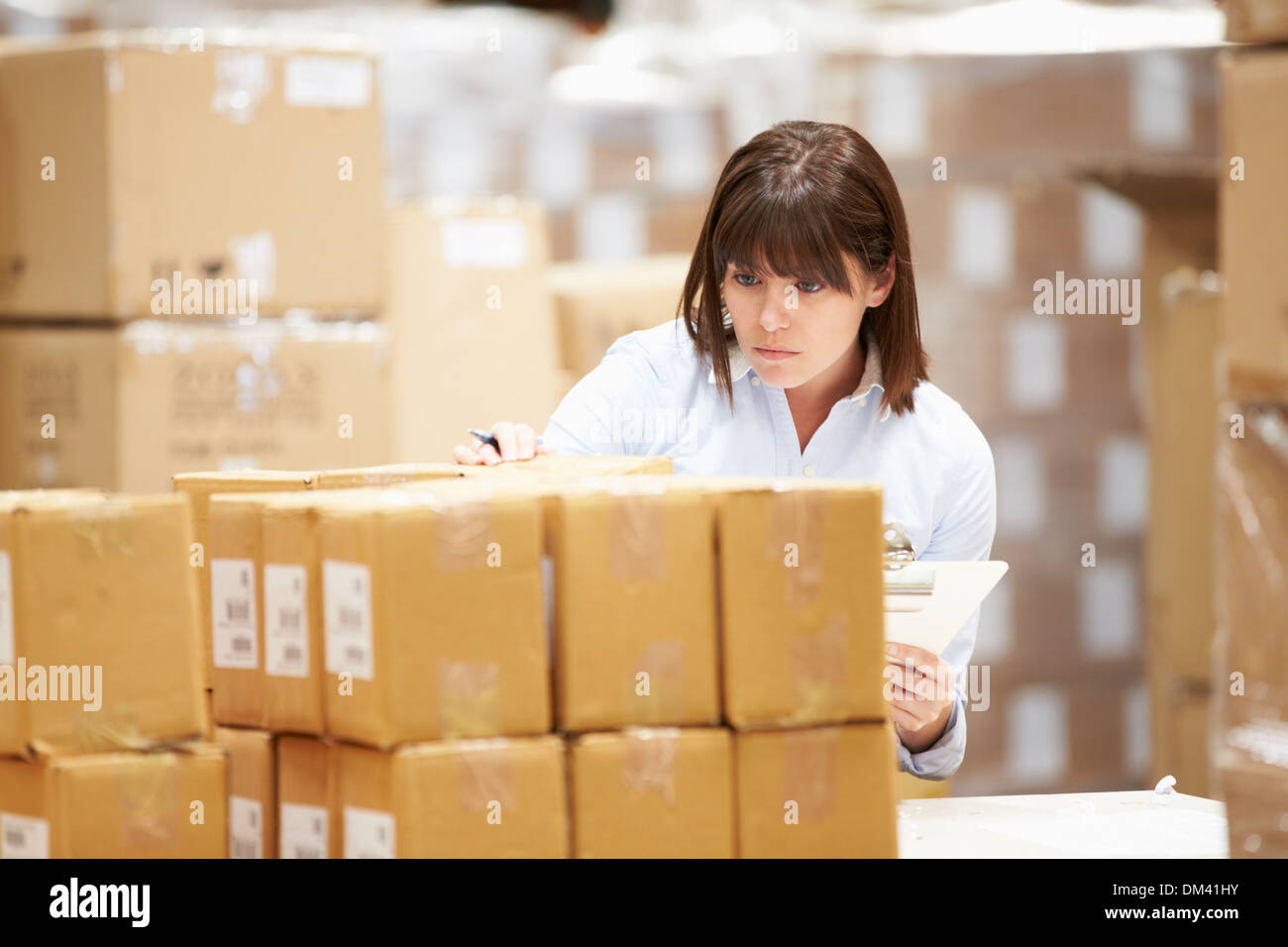 Worker In Warehouse Preparing Goods For Dispatch Stock Photo