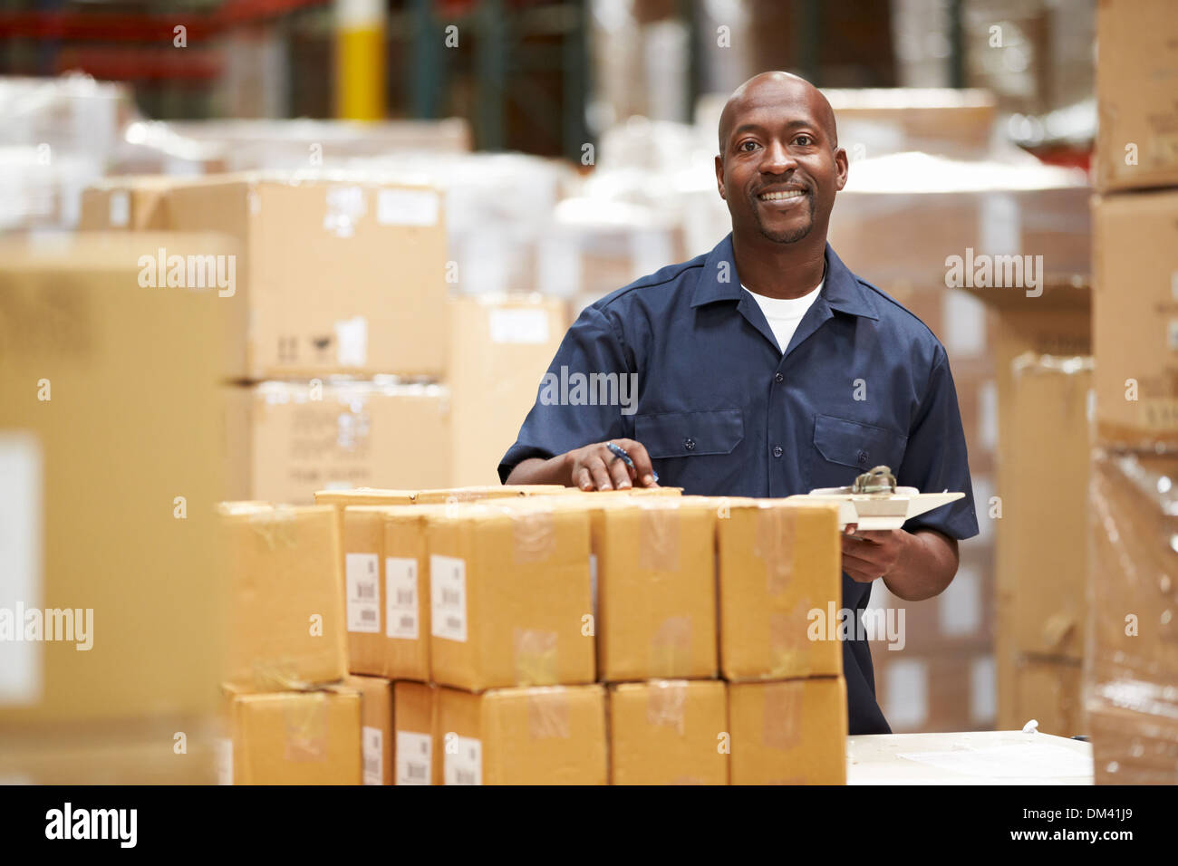 Worker In Warehouse Preparing Goods For Dispatch Stock Photo