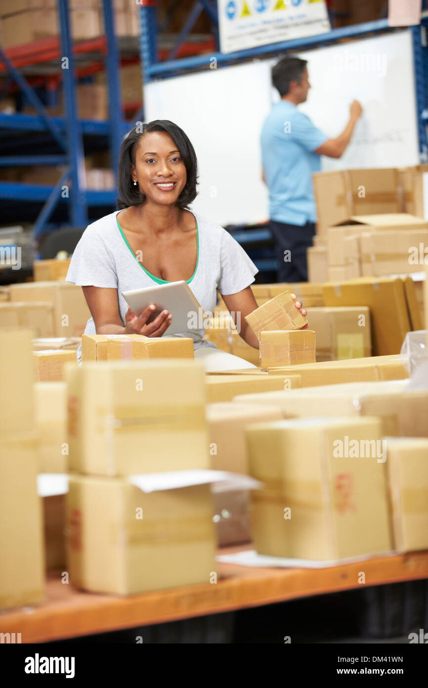 Workers In Warehouse Preparing Goods For Dispatch Stock Photo