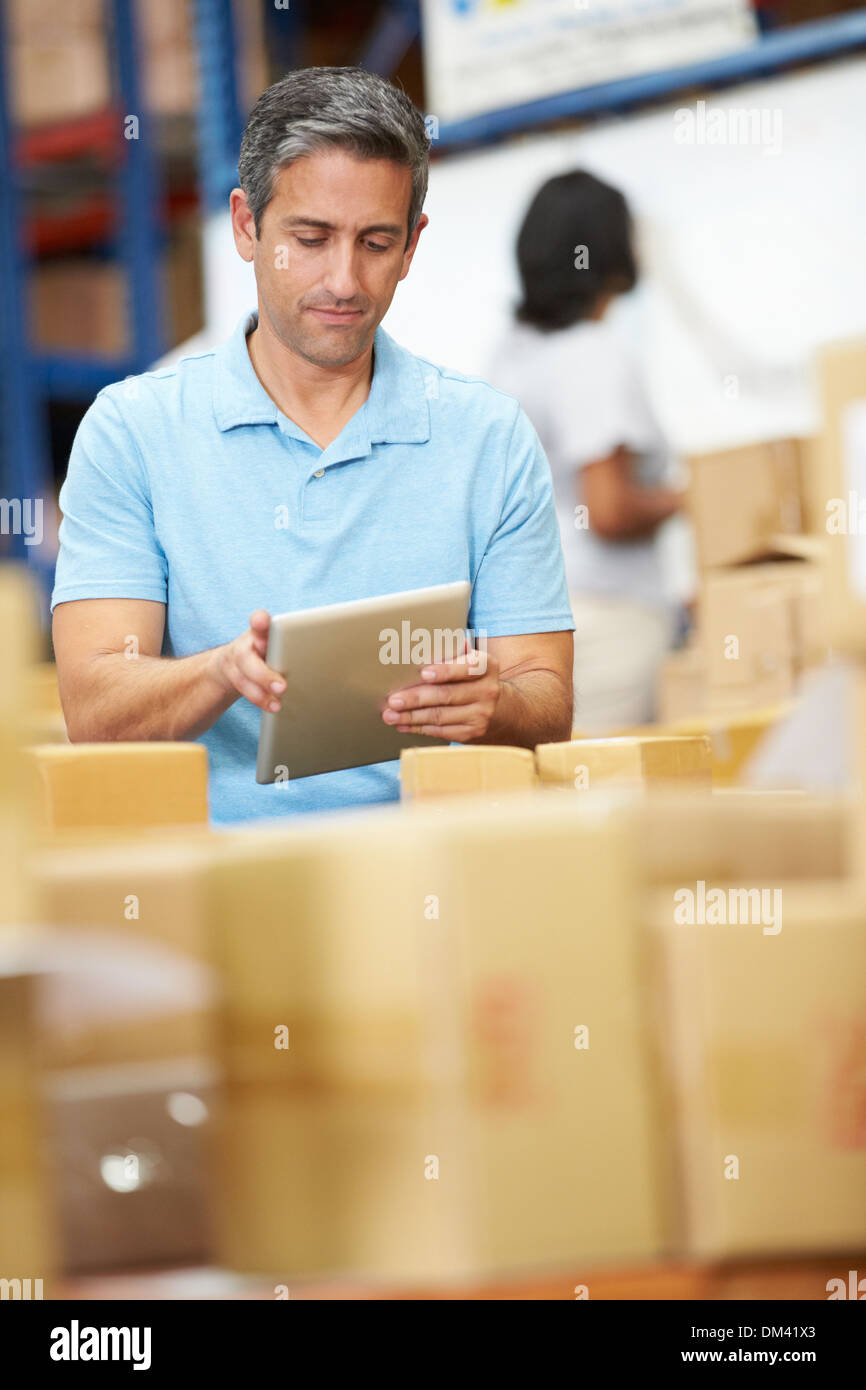 Workers In Warehouse Preparing Goods For Dispatch Stock Photo