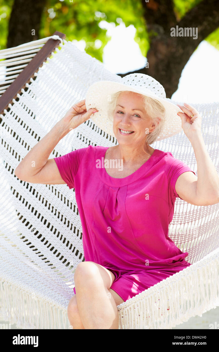 Senior Woman Relaxing In Beach Hammock Stock Photo - Alamy