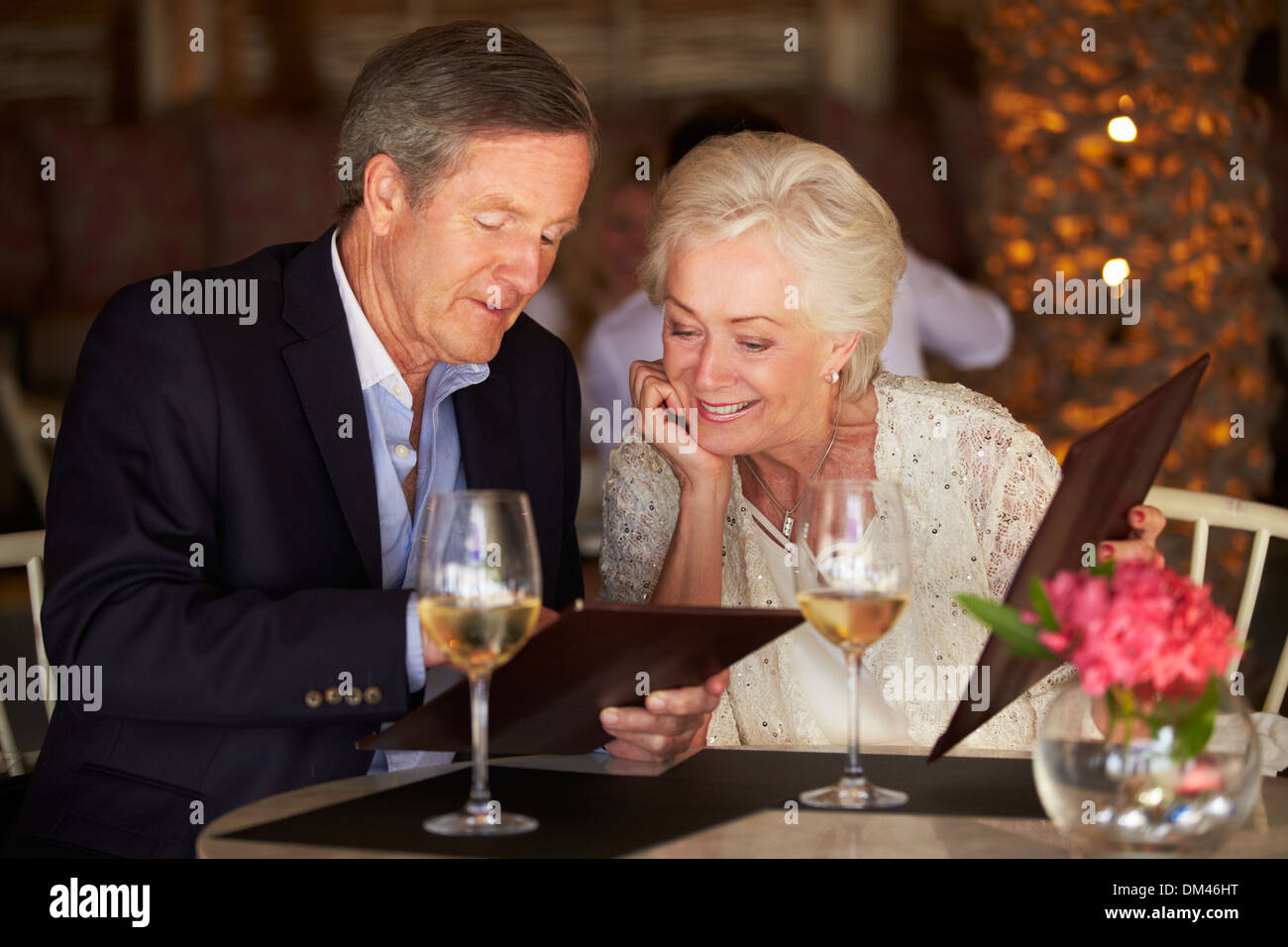 Senior Couple Choosing From Menu In Restaurant Stock Photo