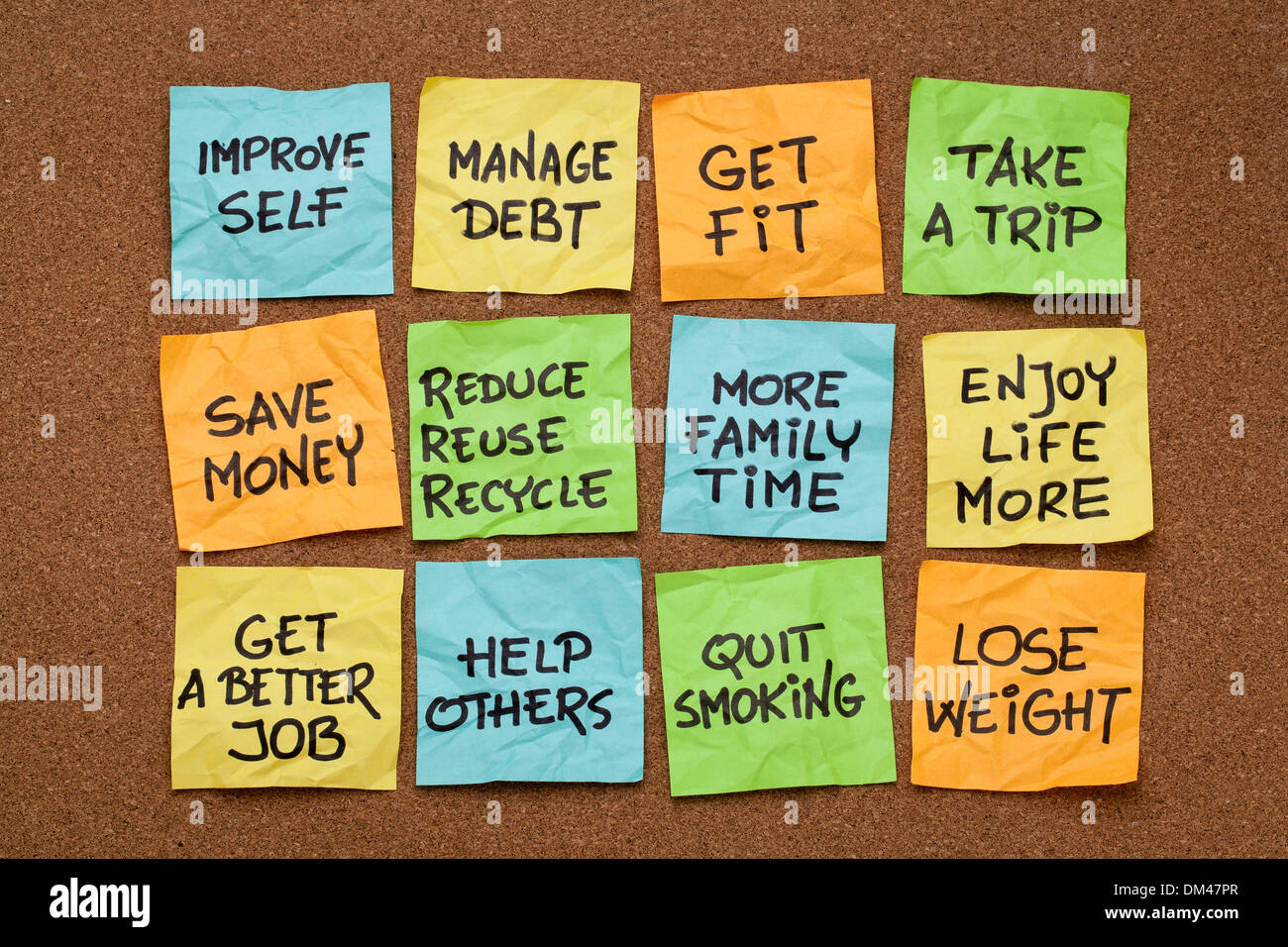 popular new year resolutions - colorful sticky notes on a cork board Stock Photo