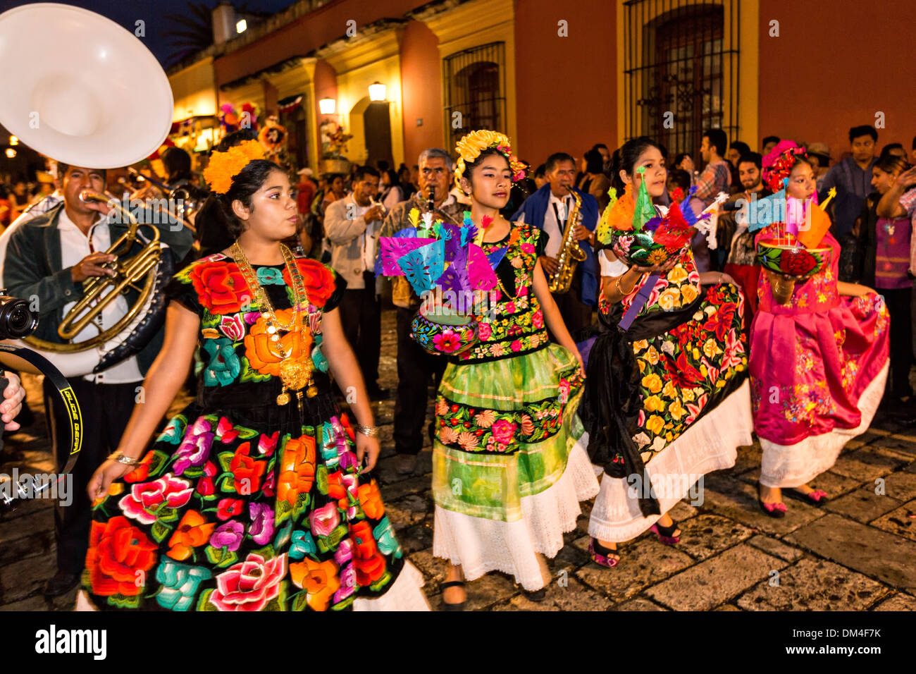 Young women dressed in traditional costumes parade in a comparsas past the Santo Domingo de Guzmn Church during the Day of the Dead Festival known in Spanish as Da de Muertos on Young women dressed in traditional costumes parade in a comparsas past the Santo Domingo de Guzmn Church during the Day of the Dead Festival known in Spanish as Da de Muertos on