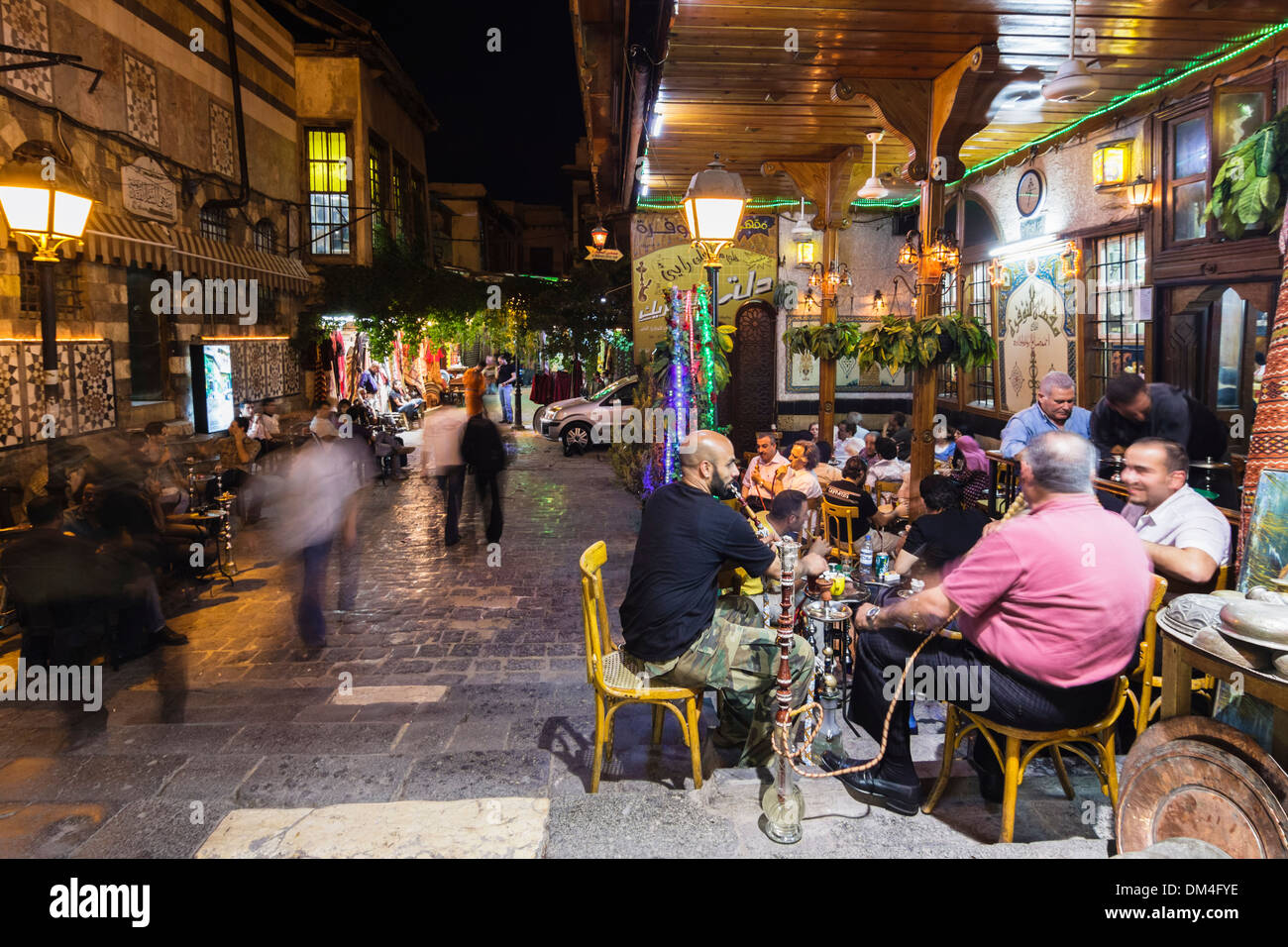Men smoking hookah outdoor at Al Nawfara coffeehouse, Damascus, Syria Stock Photo